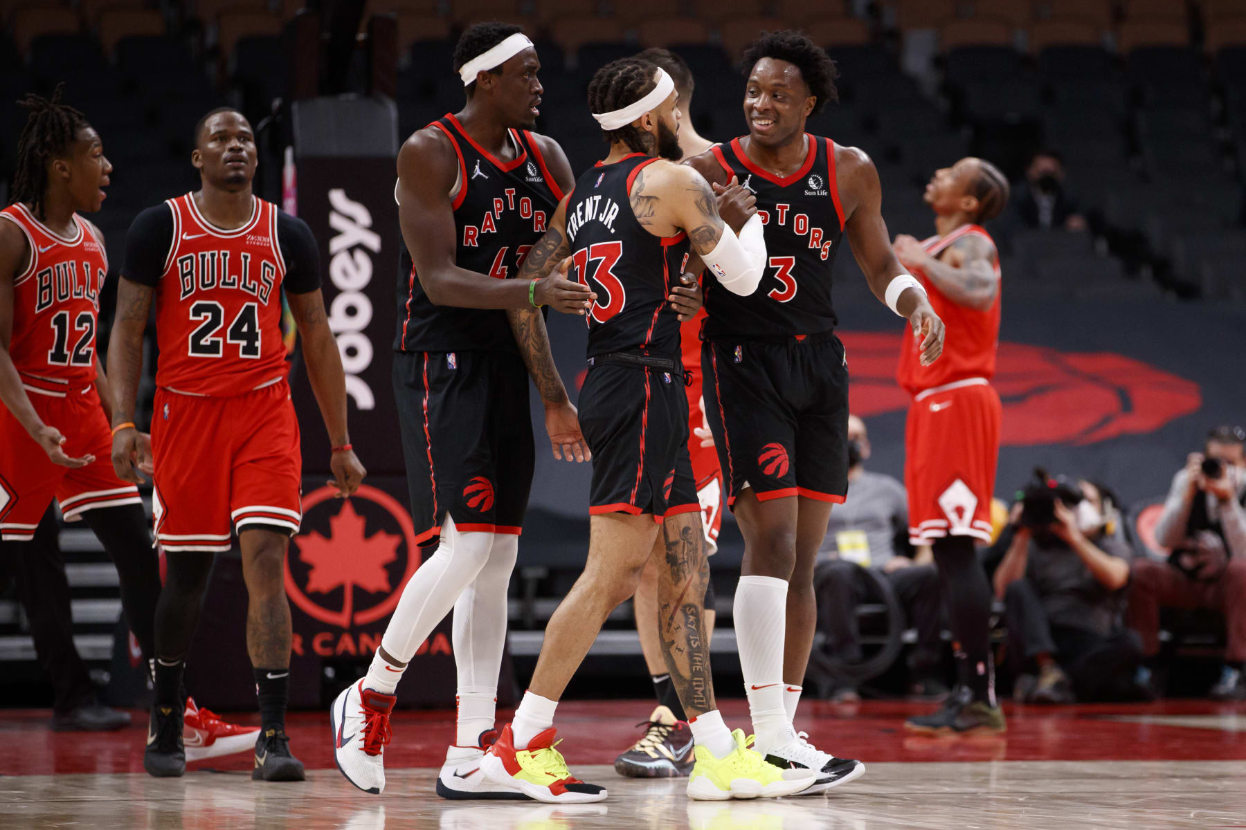 TORONTO, ON - FEBRUARY 03: OG Anunoby #3 and Pascal Siakam #43 celebrate a three pointer from Gary Trent Jr. #33 of the Toronto Raptors late in overtime of their NBA game at Scotiabank Arena on February 3, 2022 in Toronto, Canada. NOTE TO USER: User expressly acknowledges and agrees that, by downloading and or using this Photograph, user is consenting to the terms and conditions of the Getty Images License Agreement. (Photo by Cole Burston/Getty Images)