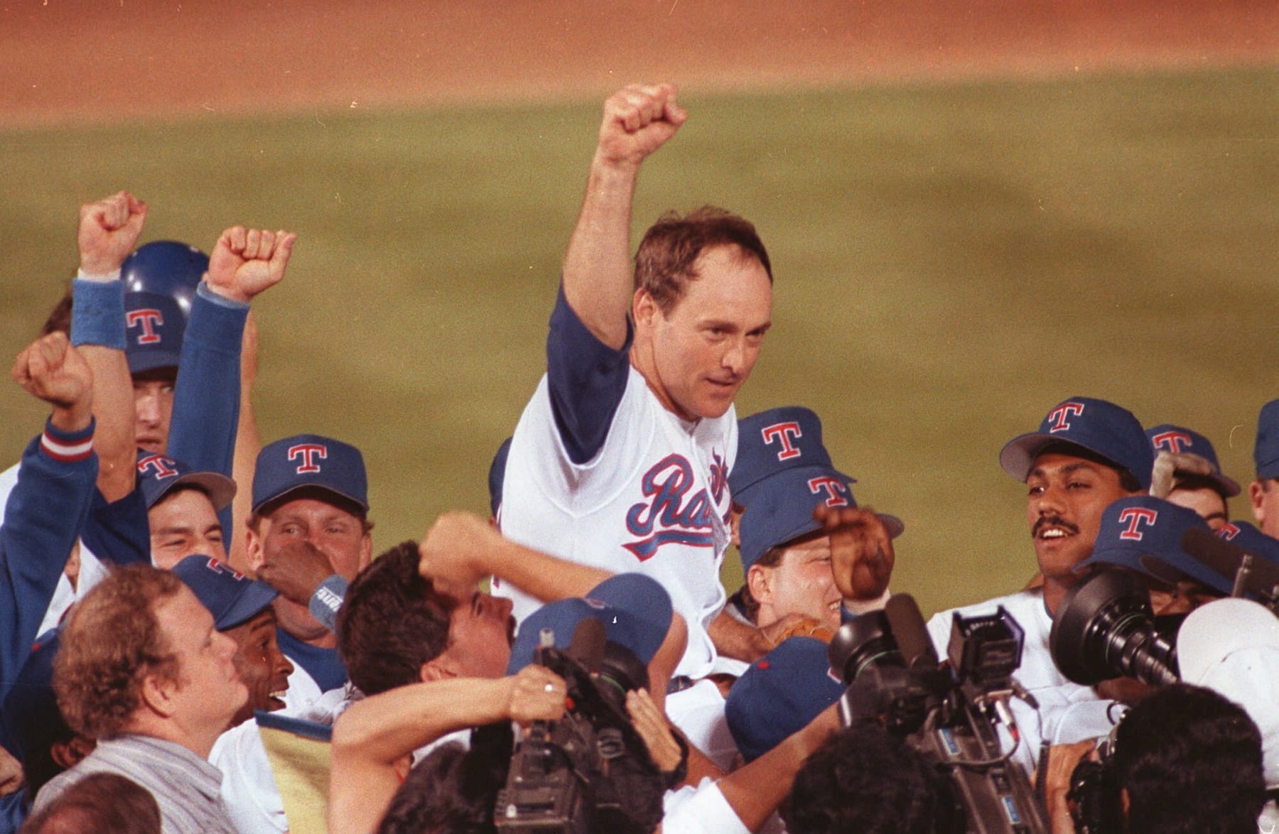 FILE - In this May 1, 1991, file photo, Texas Rangers pitcher Nolan Ryan is carried off the field by his teammates after throwing his seventh no-hitter, against the the Toronto Blue Jays in Arlington, Texas. Ryan was selected in the 12th round of the 1965 baseball draft. (AP Photo/Bill Janscha, File)
