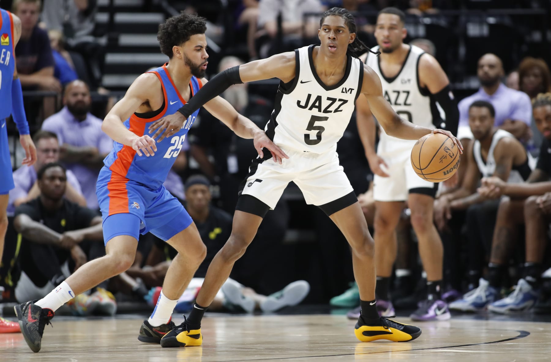 SALT LAKE CITY, UT - JULY 9: Cody Williams #5 of the Utah Jazz is pressured by Ajay Mitchell #25 of the Oklahoma City Thunder during the first half of their NBA Summer League game at the Delta Center on July 9, 2024 in Salt Lake City, Utah. NOTE TO USER: User expressly acknowledges and agrees that, by downloading and or using this photographer, user is consenting to the terms and conditions of Getty Images License Agreement.(Photo by Chris Gardner/Getty Images)