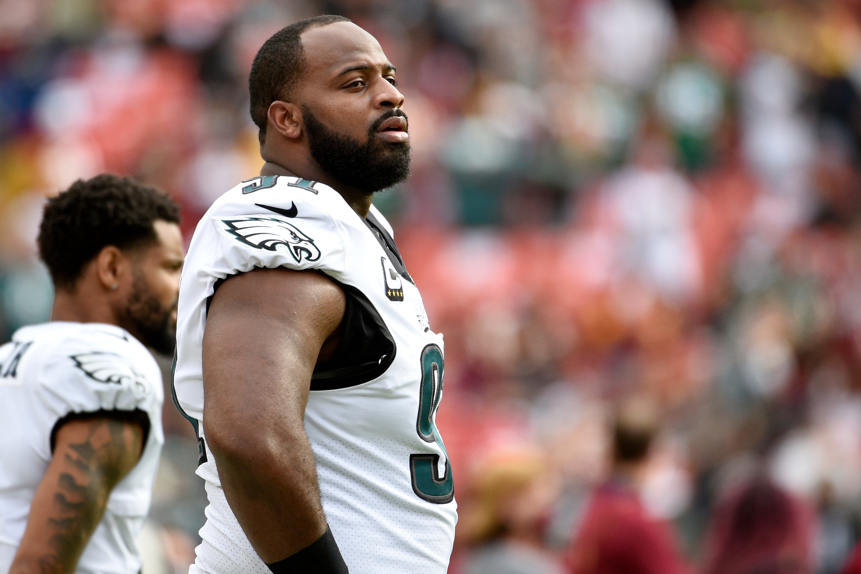 Philadelphia Eagles defensive tackle Fletcher Cox (foreground) stands on the field prior to an NFL football game against the Washington Football Team, Sunday, Jan. 2, 2022, in Landover, Md. (AP Photo/Mark Tenally)