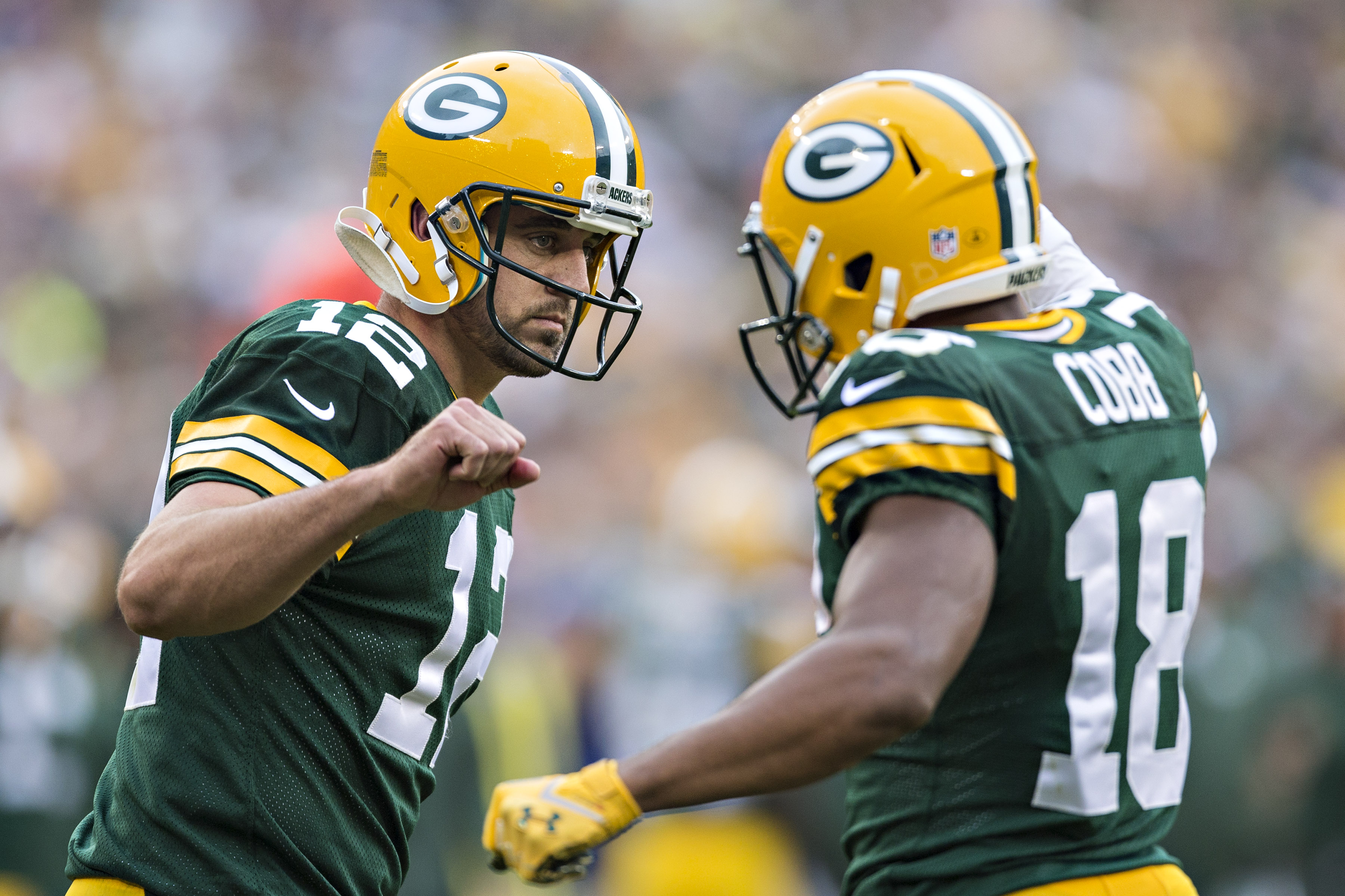 GREEN BAY, WI - SEPTEMBER 15: Aaron Rodgers #12 and Randall Cobb #18 of the Green Bay Packers celebrate after a touchdown against the Washington Redskins at Lambeau Field on September 15, 2013 in Green Bay, Wisconsin. The Packers defeated the Redskins 38-20. (Photo by Wesley Hitt/Getty Images)