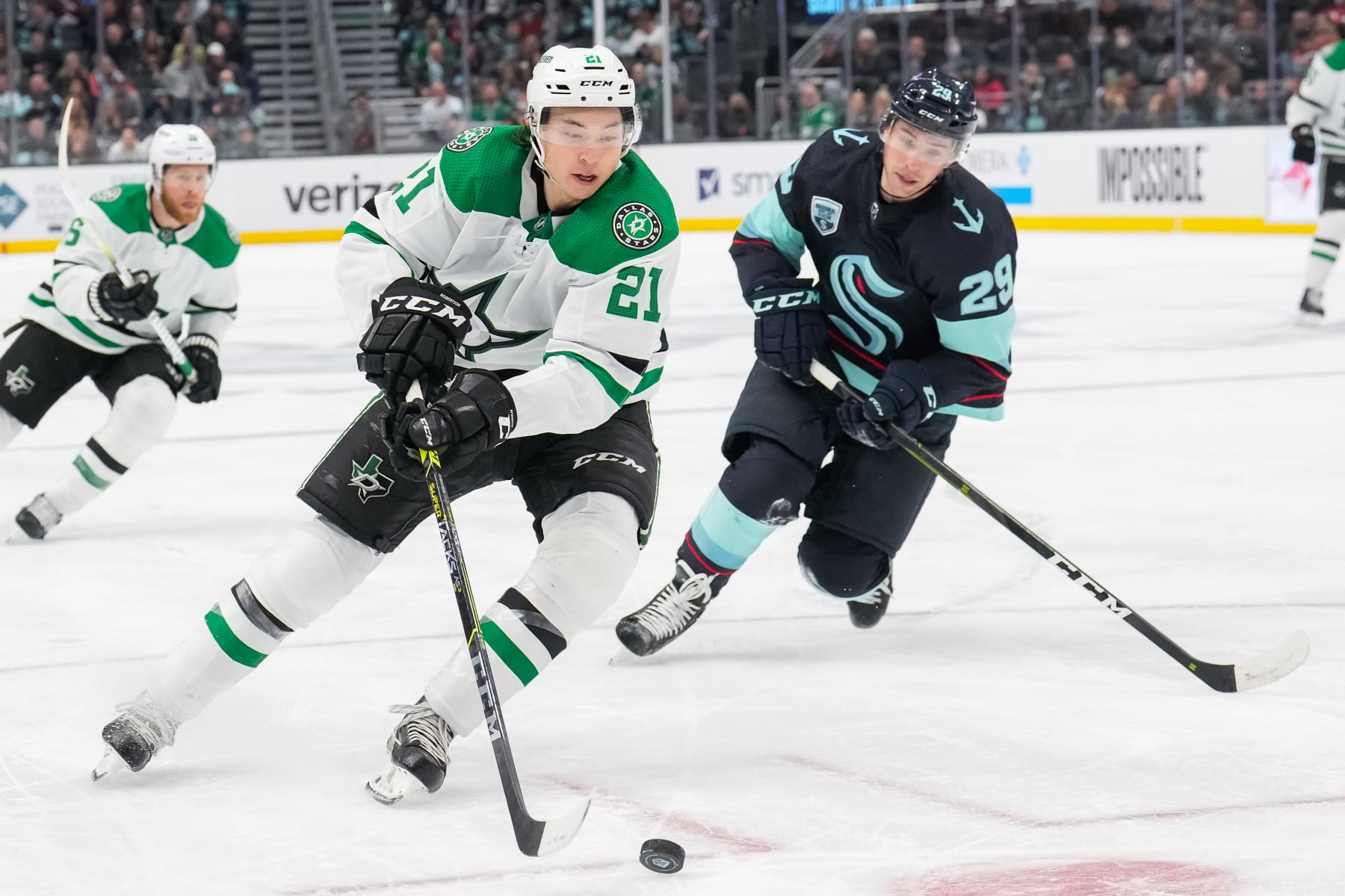 SEATTLE, WASHINGTON - APRIL 03: Jason Robertson #21 of the Dallas Stars controls the puck against Vince Dunn #29 of the Seattle Kraken during the second period at Climate Pledge Arena on April 03, 2022 in Seattle, Washington. (Photo by Christopher Mast/NHLI via Getty Images)