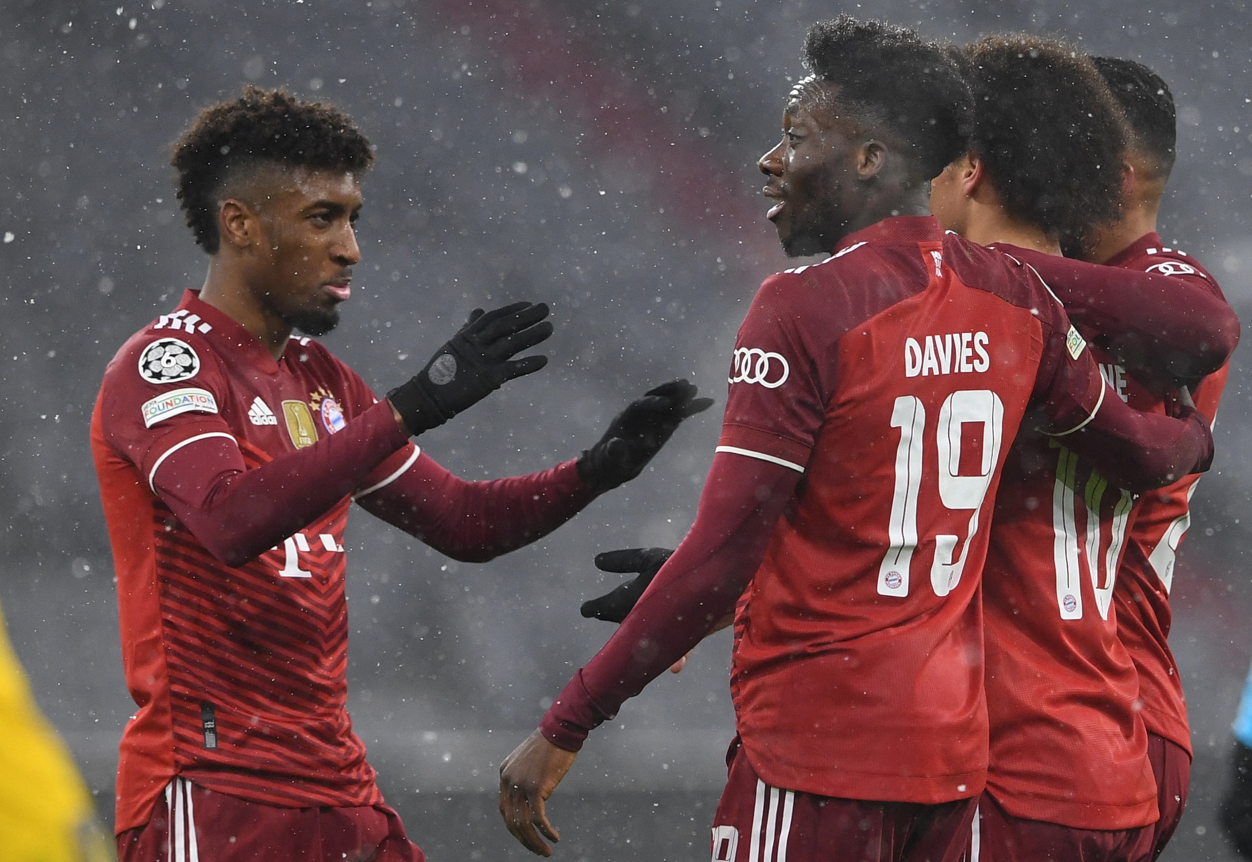 Bayern Munich's German midfielder Leroy Sane (2nd R) celebrates scoring the 2-0 with his team-mates Bayern Munich's French forward Kingsley Coman (L) and Bayern Munich's Canadian midfielder Alphonso Davies (2nd L) during the UEFA Champions League group E football match FC Bayern Munich v FC Barcelona in Munich, southern Germany on December 8, 2021. (Photo by Christof STACHE / AFP) (Photo by CHRISTOF STACHE/AFP via Getty Images)
