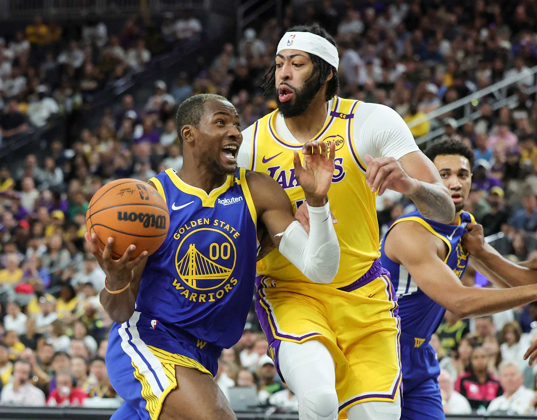 LAS VEGAS, NEVADA - OCTOBER 15: Jonathan Kuminga #00 of the Golden State Warriors drives to the basket against Anthony Davis #3 of the Los Angeles Lakers in the first quarter of their preseason game at T-Mobile Arena at T-Mobile Arena on October 15, 2024 in Las Vegas, Nevada. NOTE TO USER: User expressly acknowledges and agrees that, by downloading and or using this photograph, User is consenting to the terms and conditions of the Getty Images License Agreement. (Photo by Ethan Miller/Getty Images)