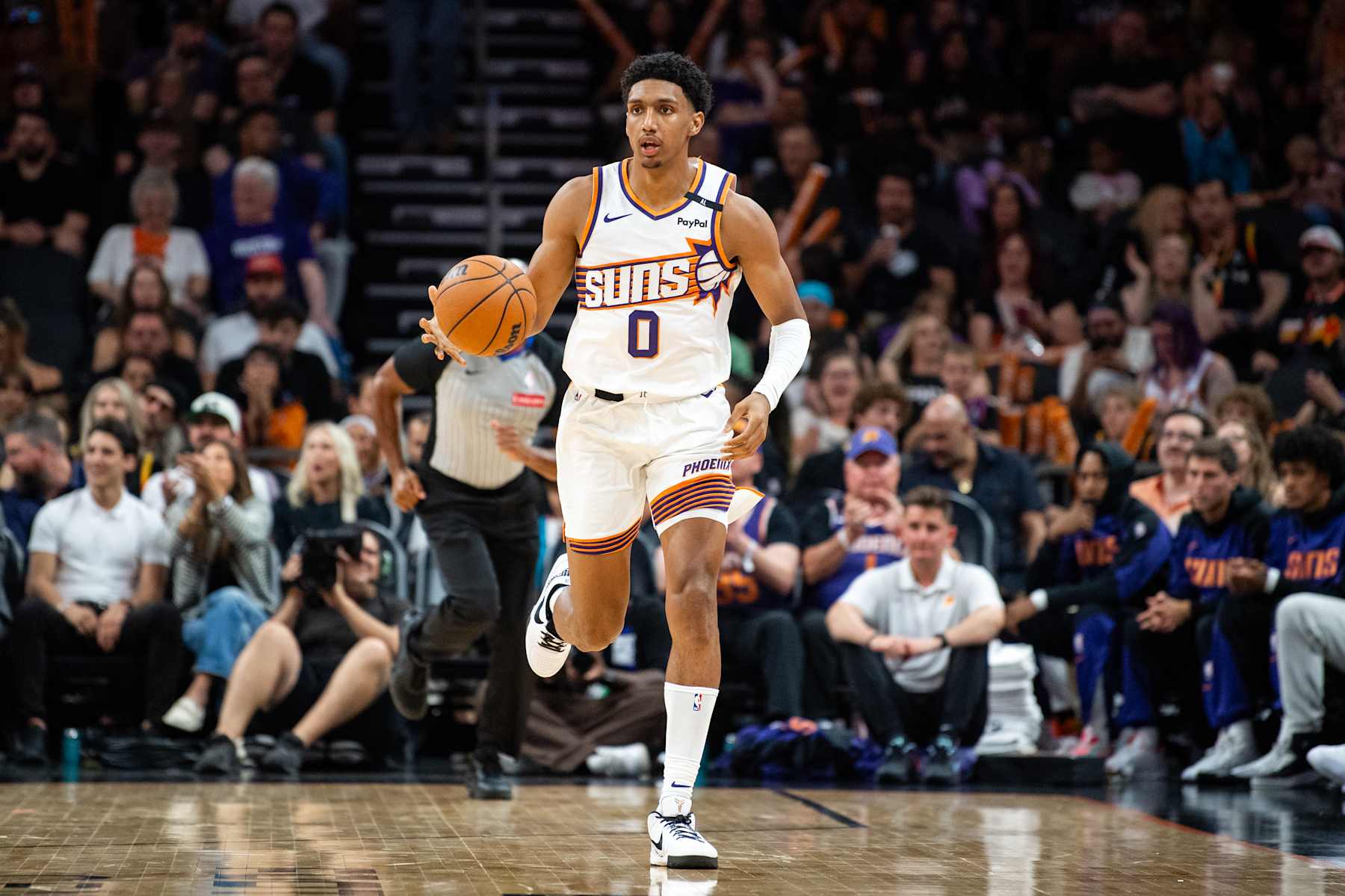 PHOENIX, ARIZONA - OCTOBER 11: Ryan Dunn #0 of the Phoenix Suns controls the ball against the Detroit Pistons during the second half of the preseason game at Footprint Center on October 11, 2024 in Phoenix, Arizona.  NOTE TO USER: User expressly acknowledges and agrees that, by downloading and/or using this photograph, user is consenting to the terms and conditions of the Getty Images License Agreement. (Photo by Kelsey Grant/Getty Images)