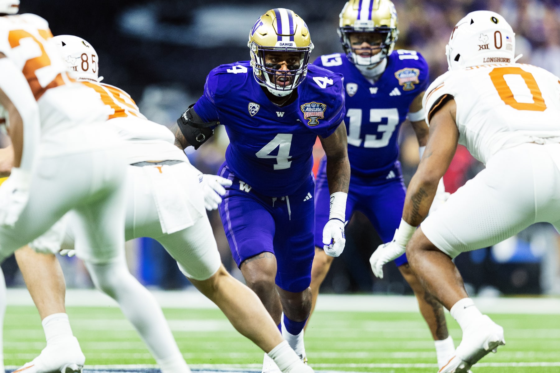 NEW ORLEANS, LA - JANUARY 01: Washington Huskies defensive lineman Zion Tupuola-Fetui (4) lines up for a play during the CFP Semifinal Allstate Sugar Bowl game between the Texas Longhorns and the Washington Huskies on January 01, 2024, at the Caesars Superdome in New Orleans, Louisiana. (Photo by John Korduner/Icon Sportswire via Getty Images)