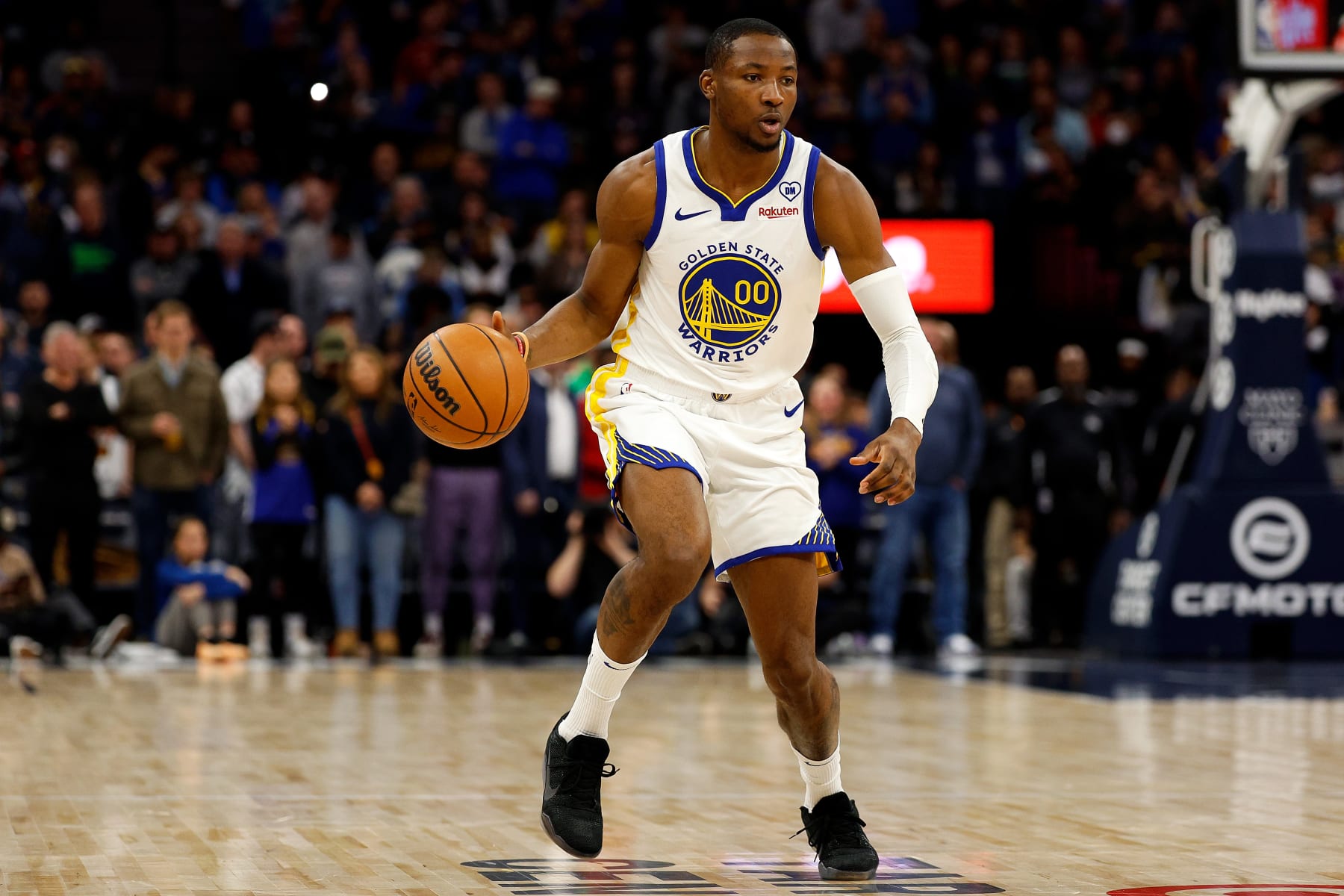 MINNEAPOLIS, MINNESOTA - MARCH 24: Jonathan Kuminga #00 of the Golden State Warriors dribbles the ball against the Minnesota Timberwolves in the first quarter at Target Center on March 24, 2024 in Minneapolis, Minnesota. The Timberwolves defeated the Warriors 114-110. NOTE TO USER: User expressly acknowledges and agrees that, by downloading and or using this photograph, User is consenting to the terms and conditions of the Getty Images License Agreement. (Photo by David Berding/Getty Images)