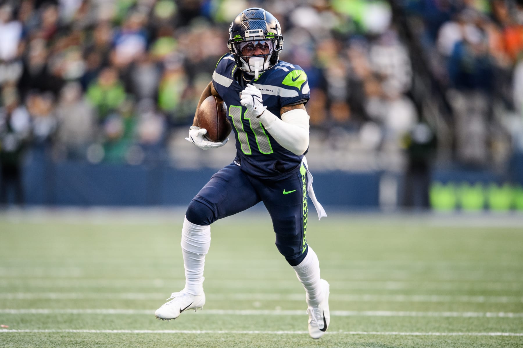 SEATTLE, WASHINGTON - NOVEMBER 27: Marquise Goodwin #11 of the Seattle Seahawks carries the ball during the second half of the game against the Las Vegas Raiders at Lumen Field on November 27, 2022 in Seattle, Washington. (Photo by Jane Gershovich/Getty Images)