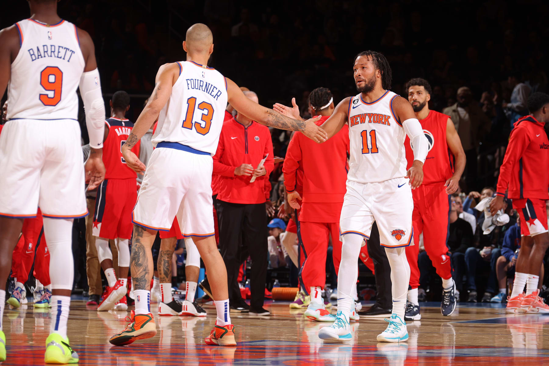 NEW YORK, NY - OCTOBER 14:  Jalen Brunson #11 and Evan Fournier #13 of the New York Knicks high five during the game against the Washington Wizards on October 14, 2022 at Madison Square Garden in New York City, New York. NOTE TO USER: User expressly acknowledges and agrees that, by downloading and or using this photograph, User is consenting to the terms and conditions of the Getty Images License Agreement. Mandatory Copyright Notice: Copyright 2022 NBAE (Photo by Nathaniel S. Butler/NBAE via Getty Images)