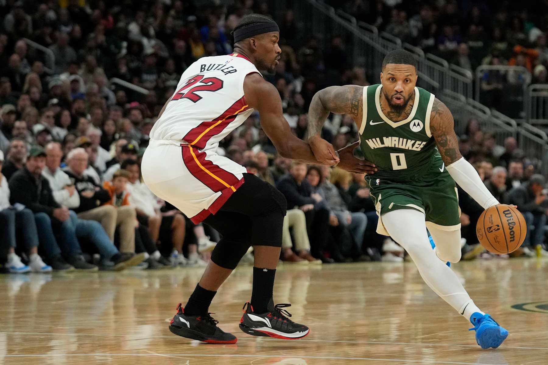 MILWAUKEE, WISCONSIN - OCTOBER 30: Damian Lillard #0 of the Milwaukee Bucks dribbles the ball against Jimmy Butler #22 of the Miami Heat during the first half at Fiserv Forum on October 30, 2023 in Milwaukee, Wisconsin. NOTE TO USER: User expressly acknowledges and agrees that, by downloading and or using this photograph, User is consenting to the terms and conditions of the Getty Images License Agreement. (Photo by Patrick McDermott/Getty Images)