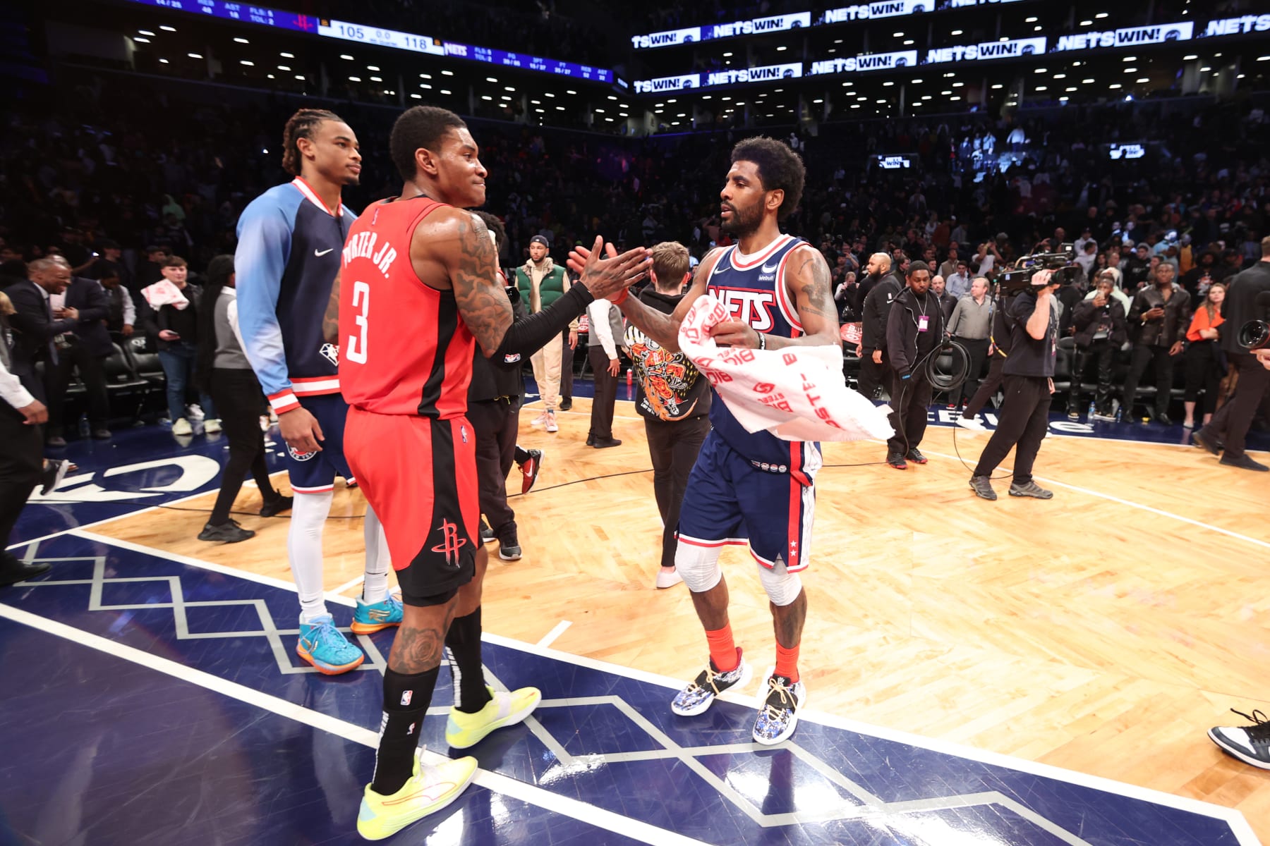 BROOKLYN, NY - APRIL 5: Kevin Porter Jr. #3 of the Houston Rockets high fives Kyrie Irving #11 of the Brooklyn Nets after the game on April 5, 2022 at Barclays Center in Brooklyn, New York. NOTE TO USER: User expressly acknowledges and agrees that, by downloading and or using this Photograph, user is consenting to the terms and conditions of the Getty Images License Agreement. Mandatory Copyright Notice: Copyright 2022 NBAE (Photo by Nathaniel S. Butler/NBAE via Getty Images)