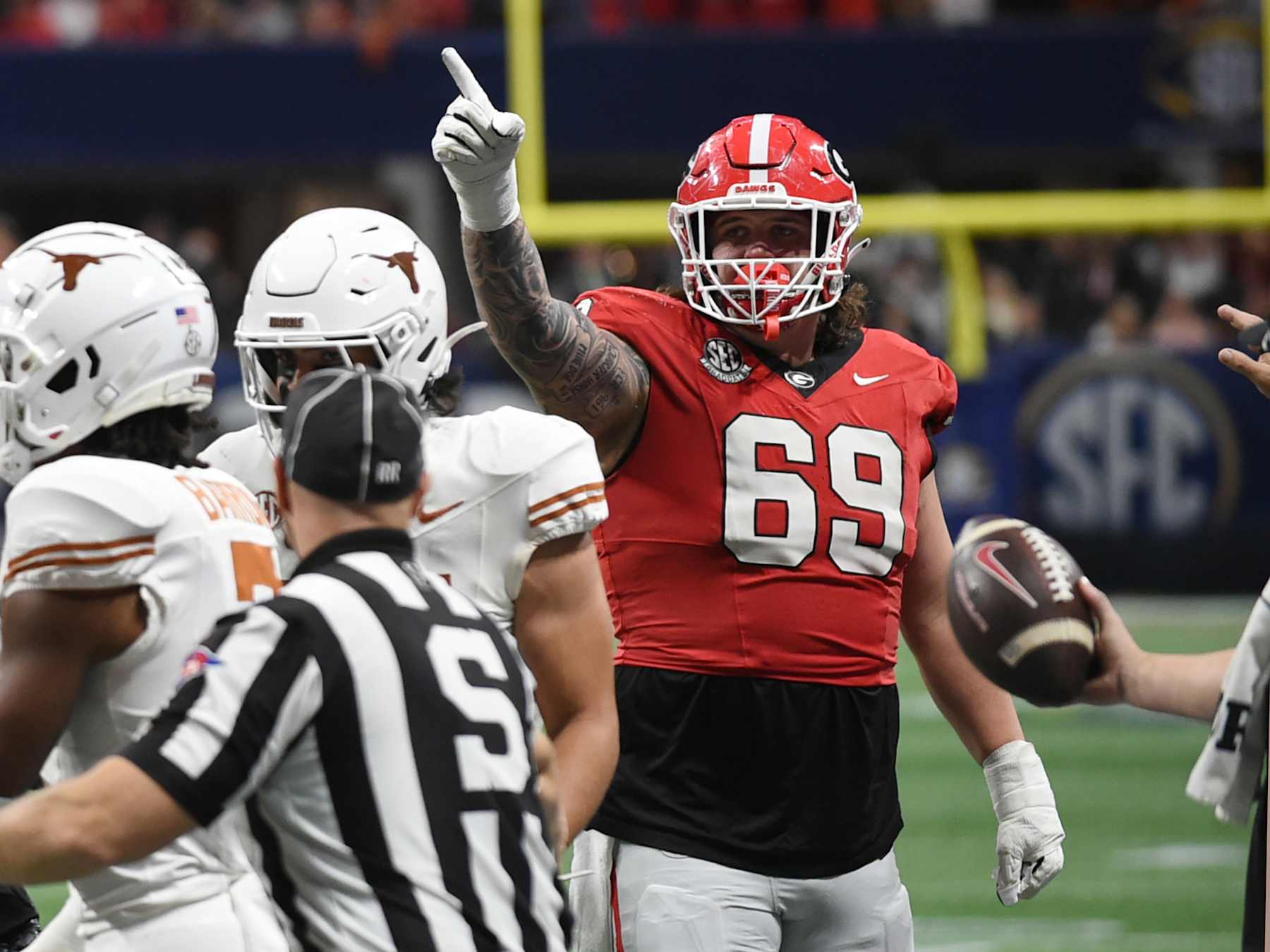 ATLANTA, GA - DECEMBER 07: Georgia Bulldogs offensive linemen Tate Ratledge (69) displays the first down signal during the SEC Championship game between the Georgia Bulldogs and the Texas Longhorns on December 07, 2024, at Mercedes-Benz Stadium in Atlanta, GA. (Photo by Jeffrey Vest/Icon Sportswire via Getty Images)