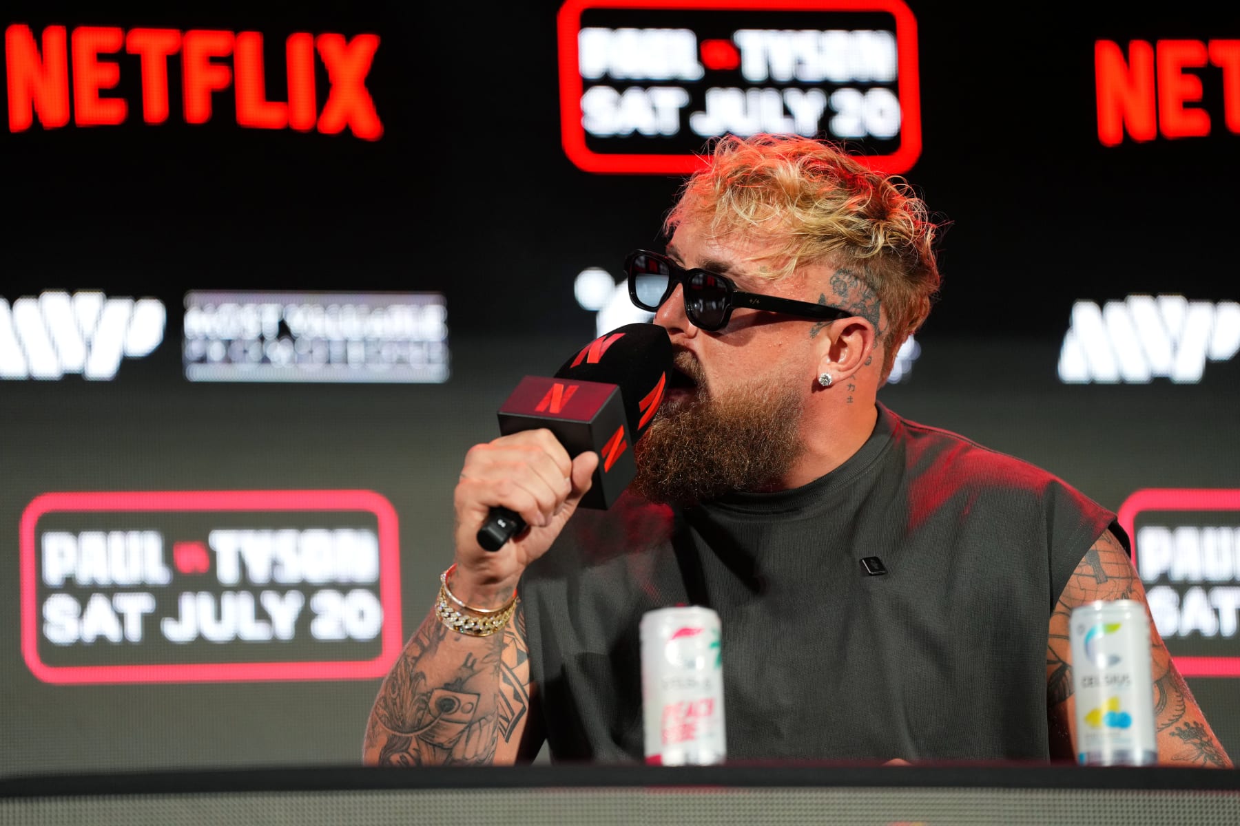 ARLINGTON, TEXAS - MAY 16: Jake Paul speaks onstage during the Jake Paul vs. Mike Tyson Boxing match Arlington press conference at Texas Live! on May 16, 2024 in Arlington, Texas.  (Photo by Cooper Neill/Getty Images for Netflix)