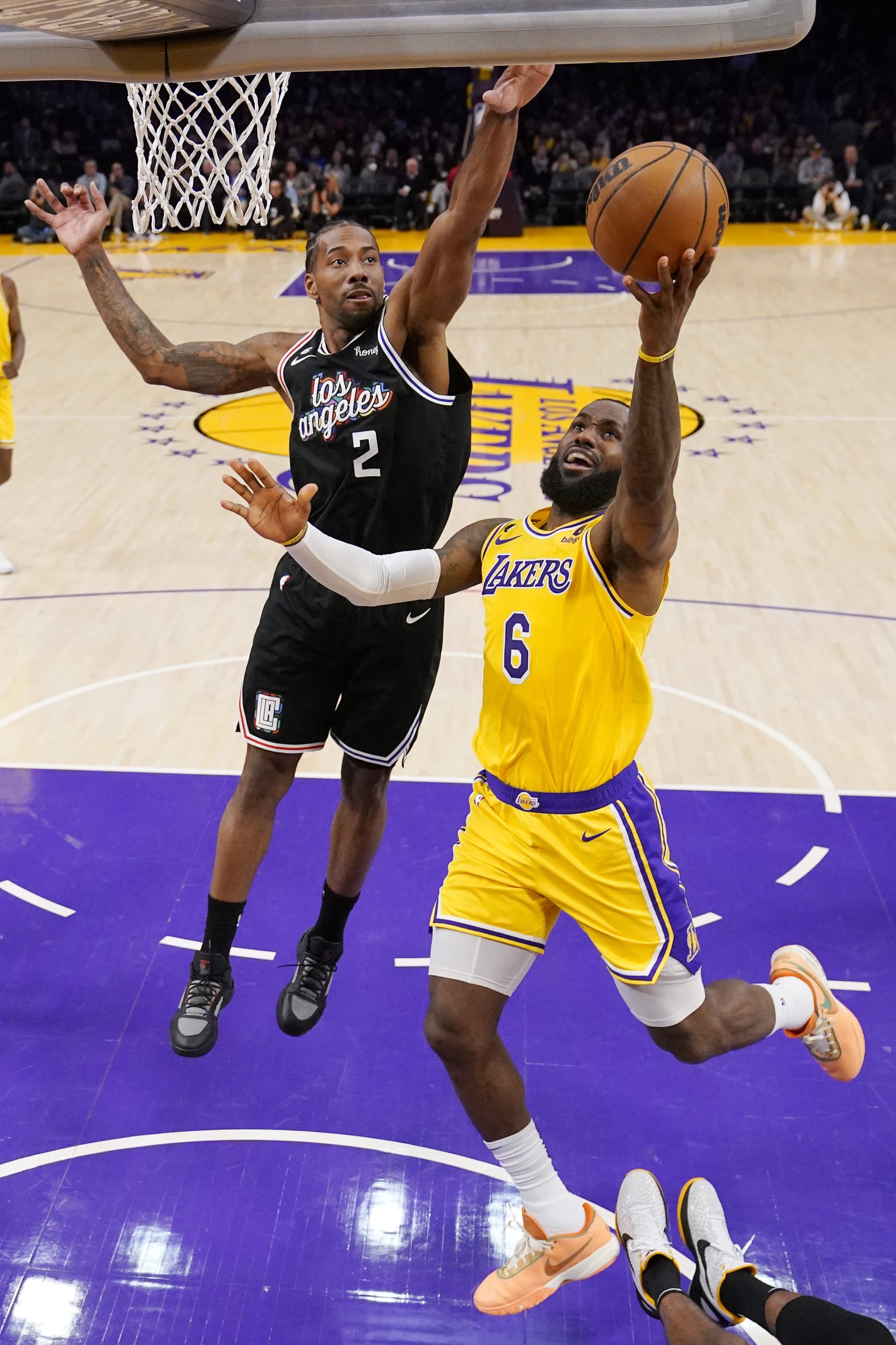 Los Angeles Lakers forward LeBron James, right, shoots as Los Angeles Clippers forward Kawhi Leonard defends during the first half of an NBA basketball game Tuesday, Jan. 24, 2023, in Los Angeles. (AP Photo/Mark J. Terrill)