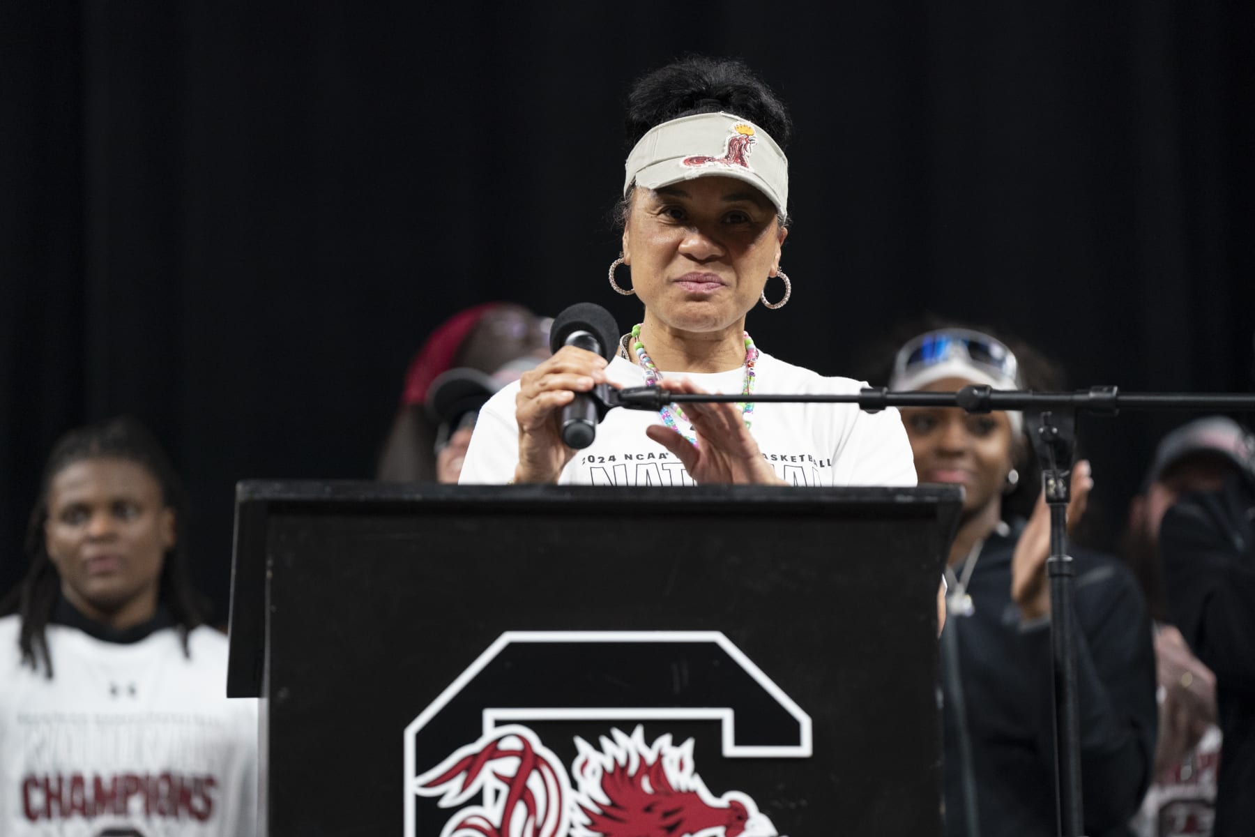 COLUMBIA, SOUTH CAROLINA - APRIL 8:  South Carolina coach Dawn Staley adjusts the microphone during an NCAA Women's Basketball Championship celebration at Colonial Life Arena on April 8, 2024 in Columbia, South Carolina. University classes that were scheduled during the event were canceled. The South Carolina Gamecocks defeated the Iowa Hawkeyes 87-75 to cap a perfect season. 
 (Photo by Sean Rayford/Getty Images)