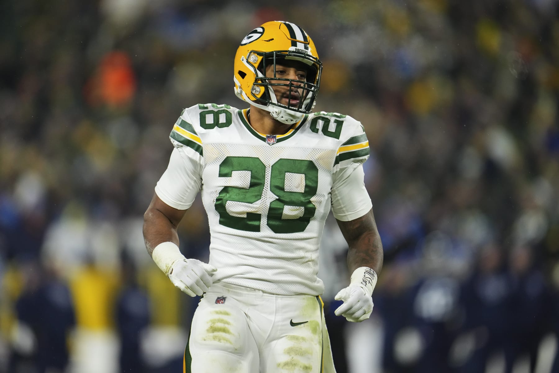 GREEN BAY, WI - NOVEMBER 17: AJ Dillon #28 of the Green Bay Packers looks down against the Tennessee Titans at Lambeau on November 17, 2022 in Green Bay, Wisconsin. (Photo by Cooper Neill/Getty Images)
