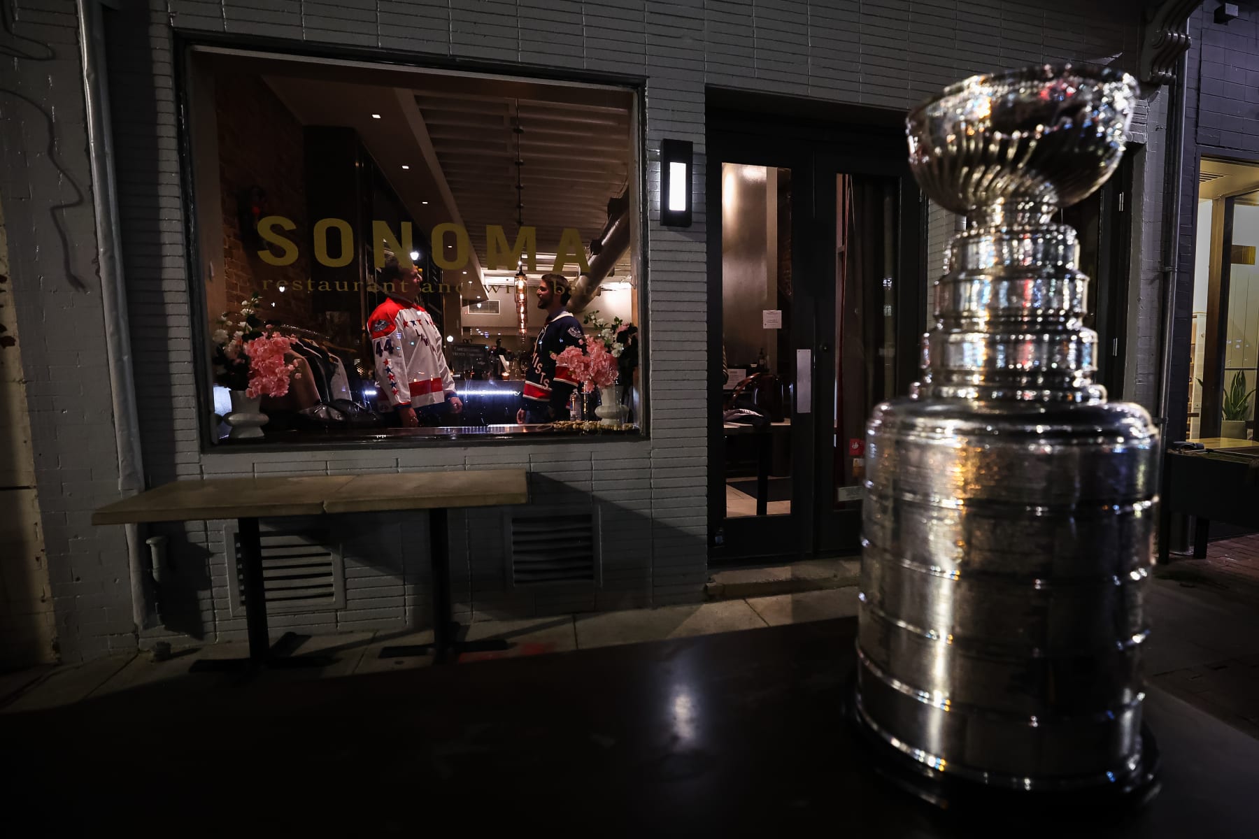 WASHINGTON, DC - FEBRUARY 28: A general view of the Stanley Cup as a team member of the lawmakers is seen interacting with a member of the Lobbyists during the 2023 Congressional Hockey Challenge VIP Reception at Sonoma Restaurant and Wine Bar on February 28, 2023 in Washington, DC. (Photo by Scott Taetsch/NHLI via Getty Images)