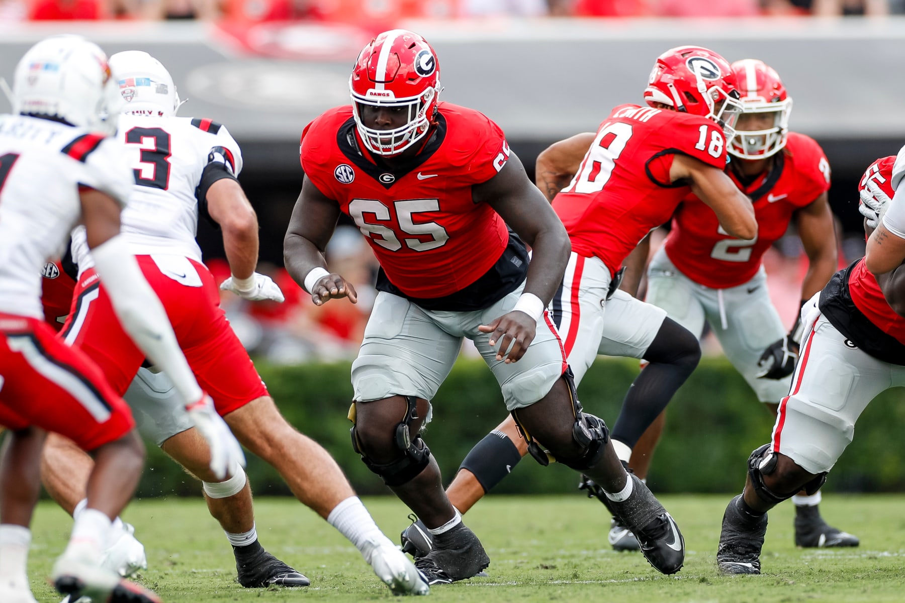 ATHENS, GEORGIA - SEPTEMBER 9: Amarius Mims #65 of the Georgia Bulldogs blocks during a game against the Ball State Cardinals at Sanford Stadium on September 9, 2023 in Athens, Georgia. (Photo by Brandon Sloter/Image Of Sport/Getty Images)