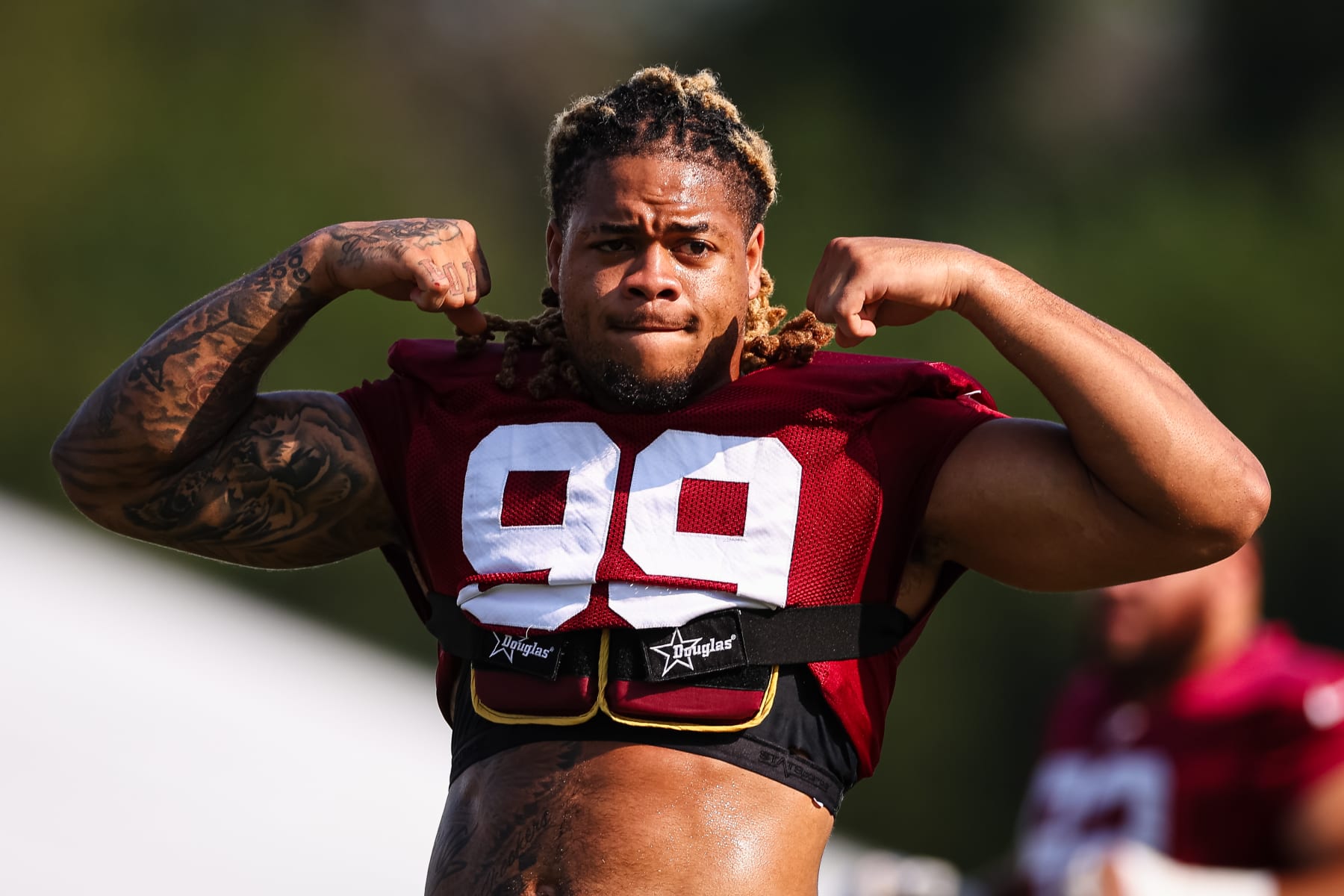 ASHBURN, VA - JULY 28: Chase Young #99 of the Washington Commanders flexes during training camp at OrthoVirginia Training Center on July 28, 2022 in Ashburn, Virginia. (Photo by Scott Taetsch/Getty Images)