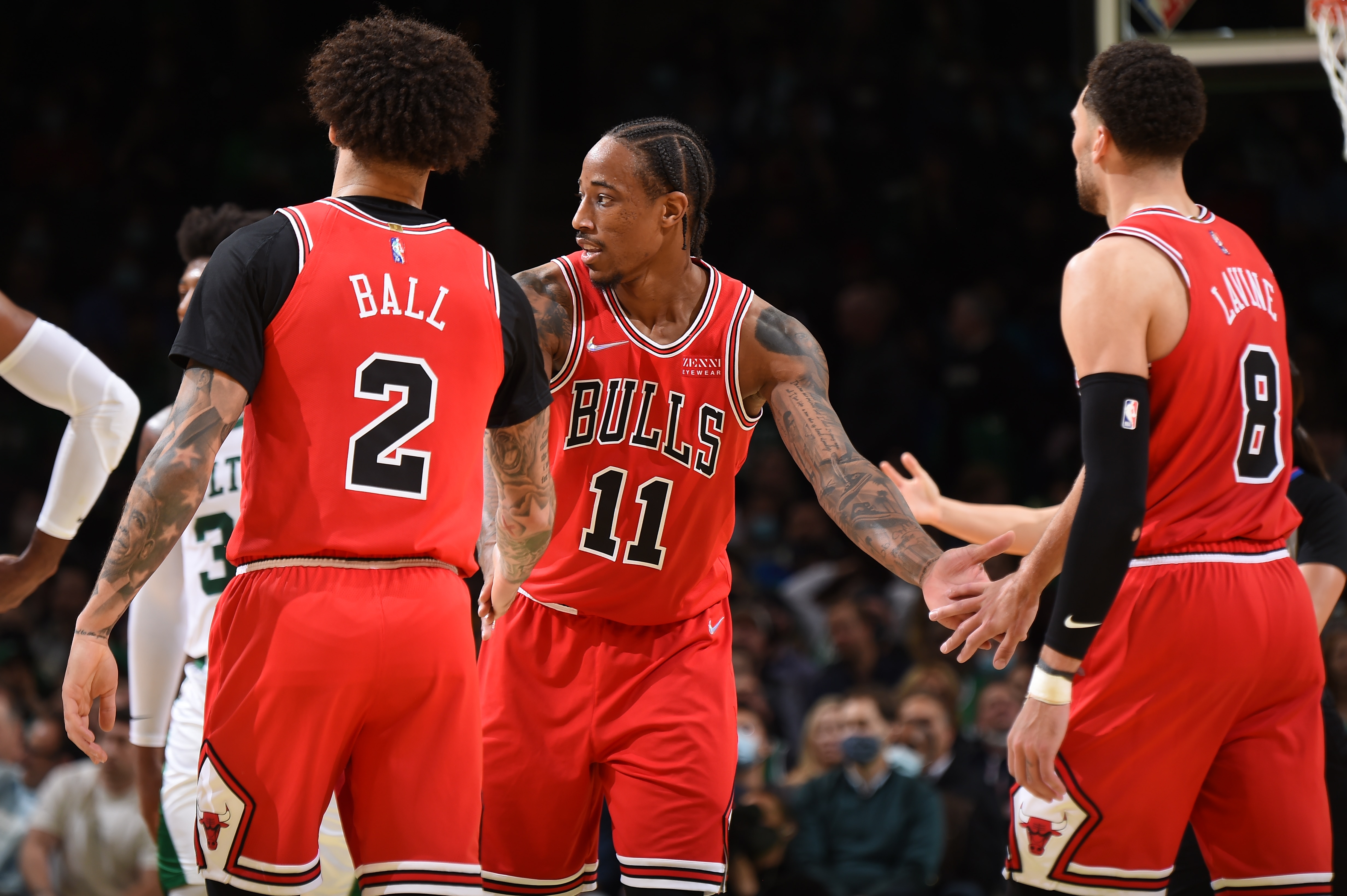 BOSTON, MA - NOVEMBER 1: Lonzo Ball #2, DeMar DeRozan #11, and Zach LaVine #8 of the Chicago Bulls hi-five during the game against the Boston Celtics on November 1, 2021 at the TD Garden in Boston, Massachusetts.  NOTE TO USER: User expressly acknowledges and agrees that, by downloading and or using this photograph, User is consenting to the terms and conditions of the Getty Images License Agreement. Mandatory Copyright Notice: Copyright 2021 NBAE  (Photo by Brian Babineau/NBAE via Getty Images)