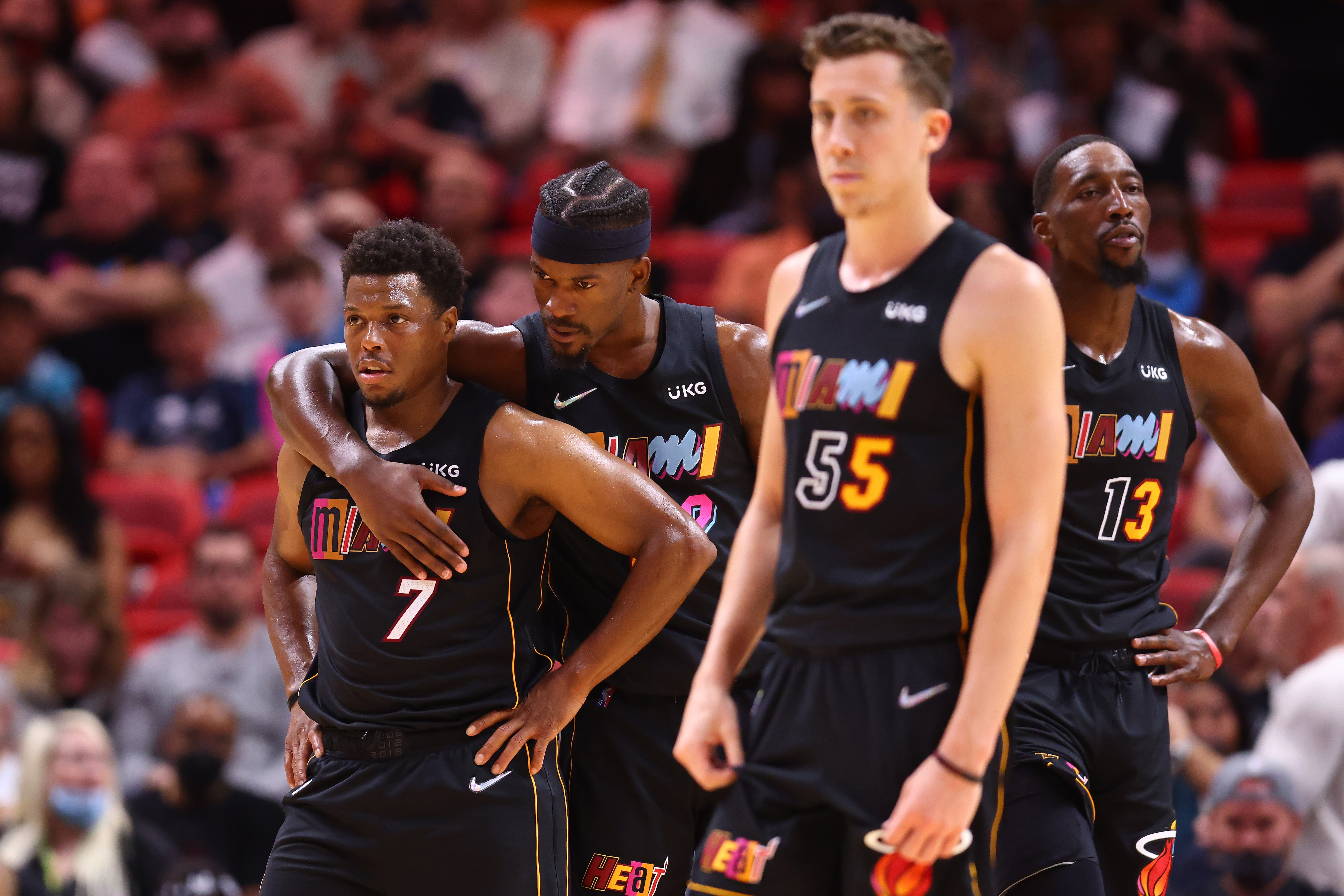 MIAMI, FLORIDA - MARCH 11: Kyle Lowry #7, Jimmy Butler #22, Duncan Robinson #55 and Bam Adebayo #13 of the Miami Heat look on against the Cleveland Cavaliers during the second half at FTX Arena on March 11, 2022 in Miami, Florida. NOTE TO USER: User expressly acknowledges and agrees that, by downloading and or using this photograph, User is consenting to the terms and conditions of the Getty Images License Agreement. (Photo by Michael Reaves/Getty Images)