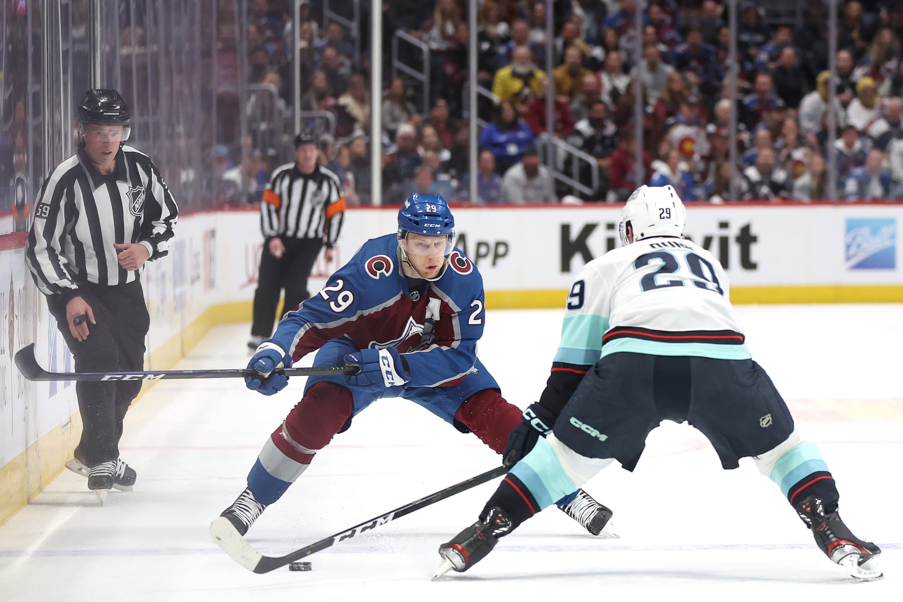 DENVER, COLORADO - APRIL 20: Nathan MacKinnon #29 of the Colorado Avalanche advances the puck against Vince Dunn #29 of the Seattle Kraken in the second period in Game Two of the First Round of the 2023 Stanley Cup Playoffs at Ball Arena on April 20, 2023 in Denver, Colorado. (Photo by Matthew Stockman/Getty Images)