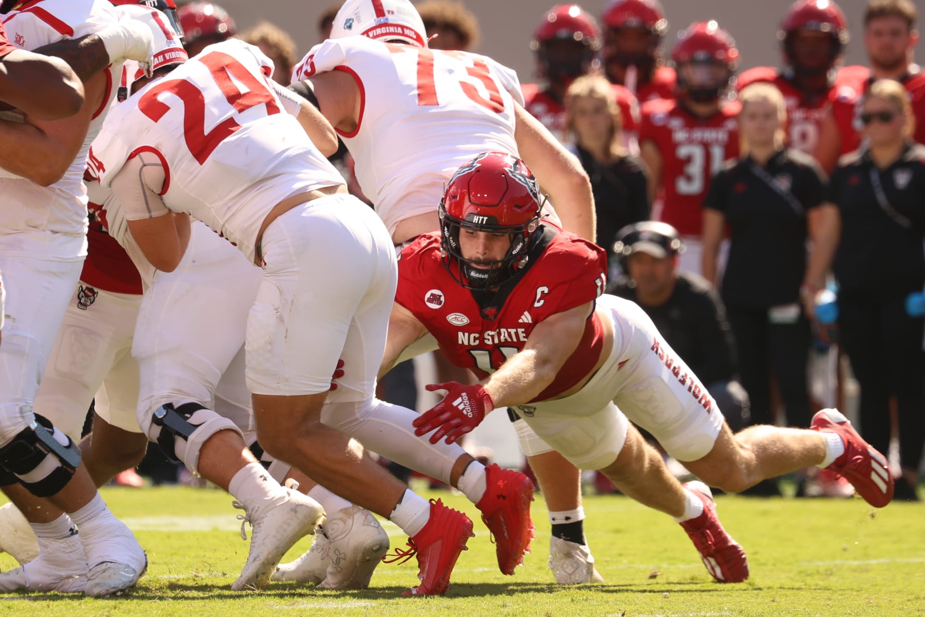 RALEIGH, NC - SEPTEMBER 16: North Carolina State Wolfpack linebacker Payton Wilson (11) tackles Virginia Military Institute Keydets running back Hunter Rice (24) during the college football game between the North Carolina State Wolfpack and the Virginia Military Institute Keydets on September 16, 2023 at Carter-Finley Stadium in Raleigh, NC. (Photo by Nicholas Faulkner/Icon Sportswire via Getty Images)