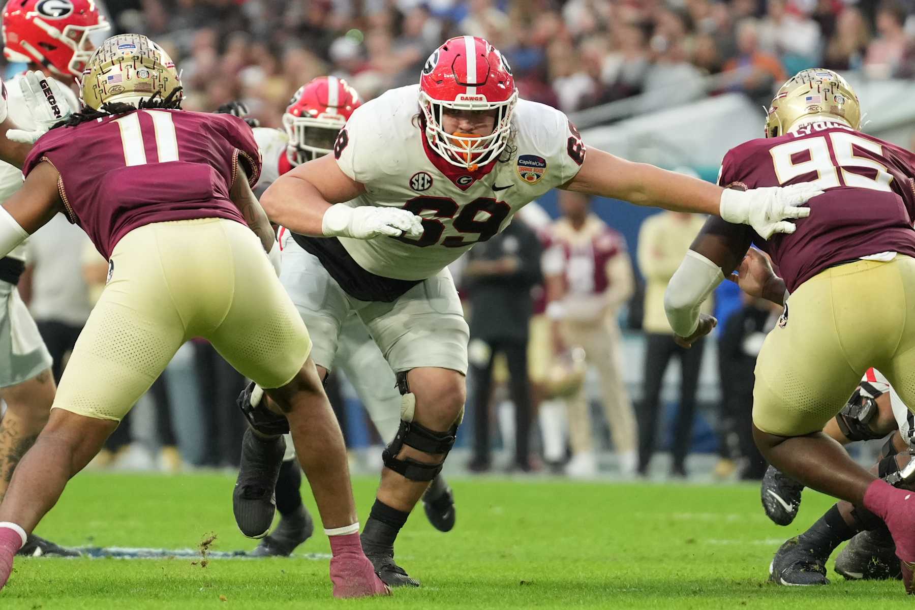 MIAMI GARDENS, FL - DECEMBER 30: Georgia Bulldogs offensive lineman Tate Ratledge (69) runs blocks during the Capital One Orange Bowl game between the Georgia Bulldogs and the Florida State Seminoles on Saturday, December 30, 2023 at Hard Rock Stadium, Miami Gardens, Fla. (Photo by Peter Joneleit/Icon Sportswire via Getty Images)