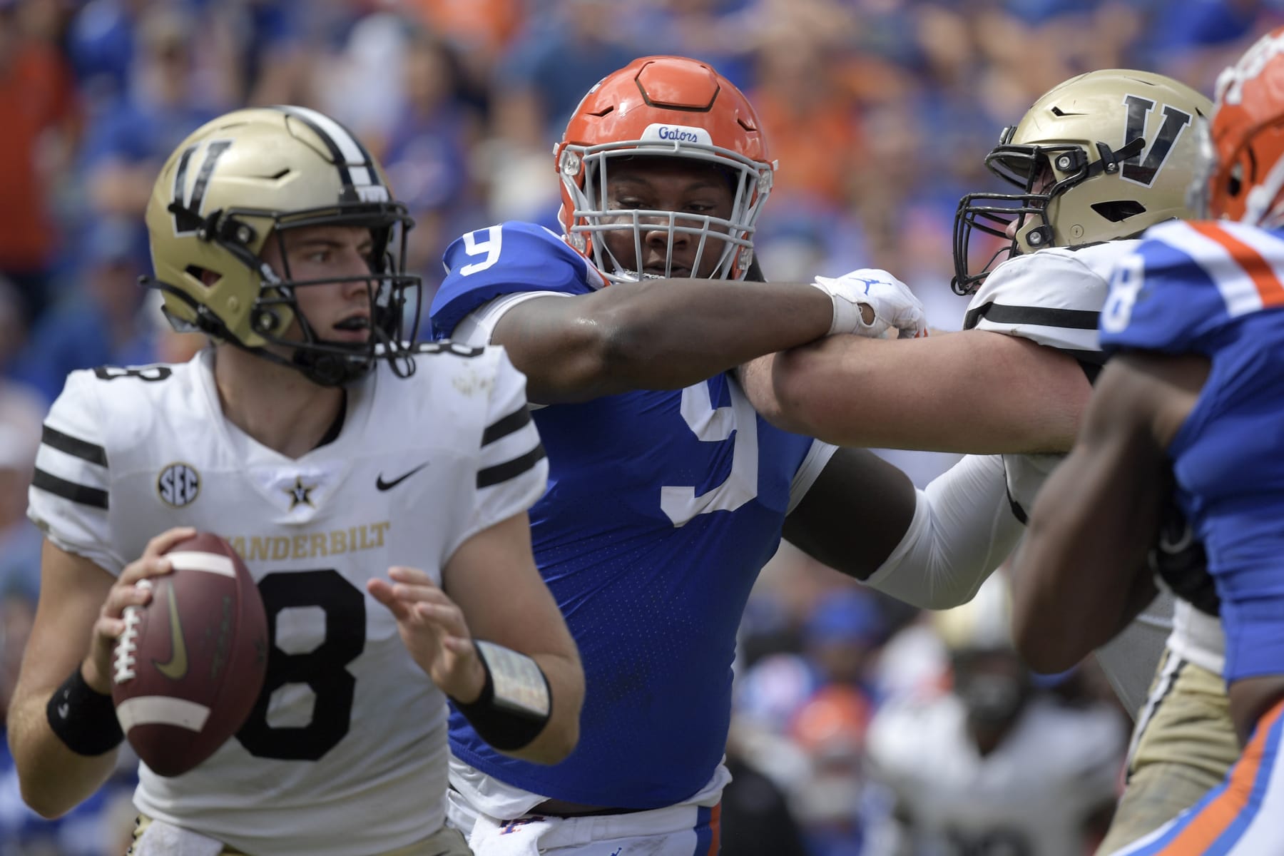 Florida defensive lineman Gervon Dexter (9) pursues as Vanderbilt quarterback Ken Seals (8) sets up to throw a pass during the second half of an NCAA college football game, Saturday, Oct. 9, 2021, in Gainesville, Fla. (AP Photo/Phelan M. Ebenhack)