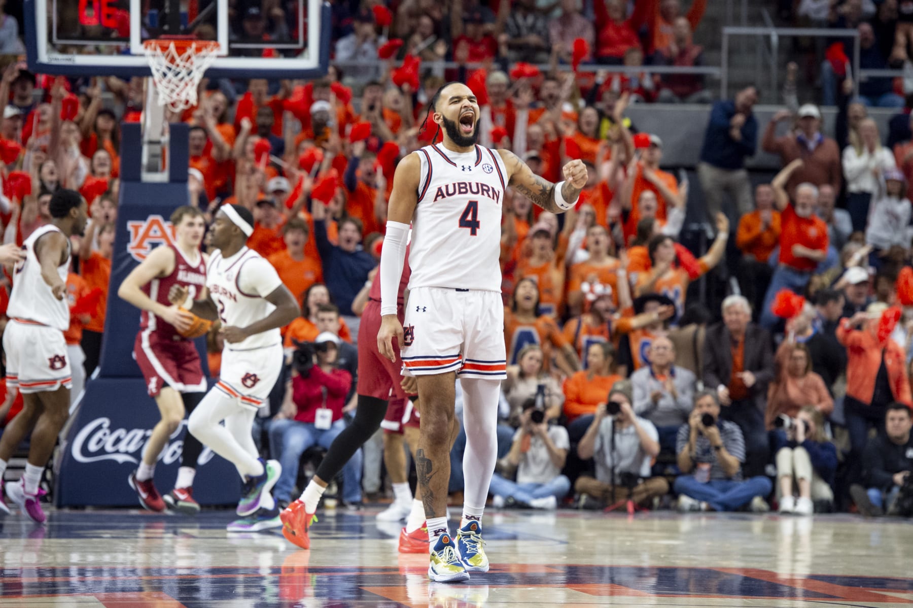 AUBURN, ALABAMA - FEBRUARY 07: Johni Broome #4 of the Auburn Tigers reacts after making a shot during the first half of their game against the Alabama Crimson Tide at Neville Arena on February 07, 2024 in Auburn, Alabama. (Photo by Michael Chang/Getty Images)