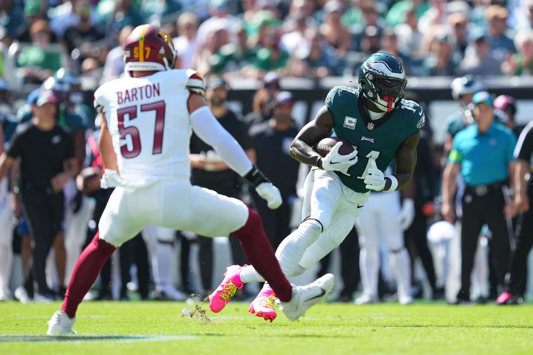 PHILADELPHIA, PENNSYLVANIA - OCTOBER 01: A.J. Brown #11 of the Philadelphia Eagles runs with the ball against Cody Barton #57 of the Washington Commanders at Lincoln Financial Field on October 01, 2023 in Philadelphia, Pennsylvania. (Photo by Mitchell Leff/Getty Images)