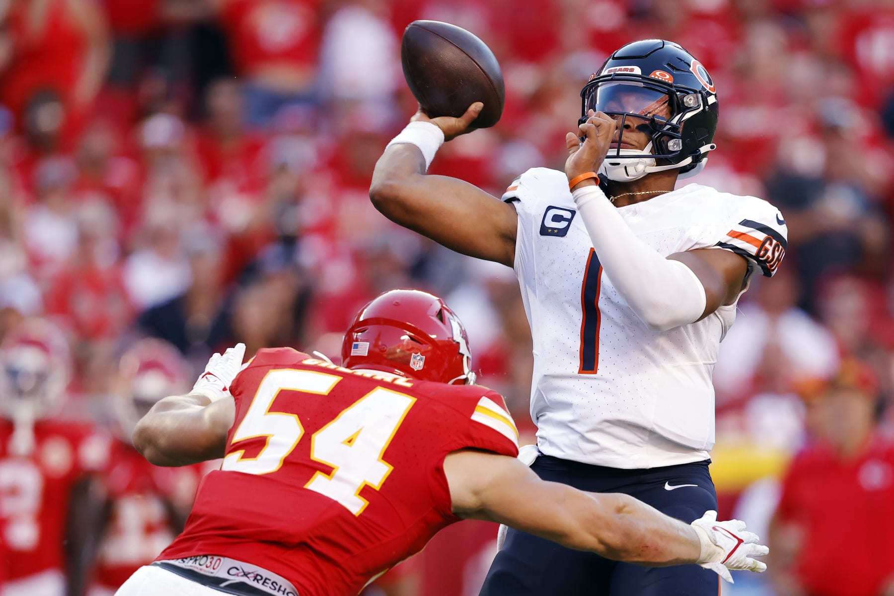 KANSAS CITY, MISSOURI - SEPTEMBER 24: Leo Chenal #54 of the Kansas City Chiefs pressures Justin Fields #1 of the Chicago Bears in the fourth quarter at GEHA Field at Arrowhead Stadium on September 24, 2023 in Kansas City, Missouri. (Photo by David Eulitt/Getty Images)