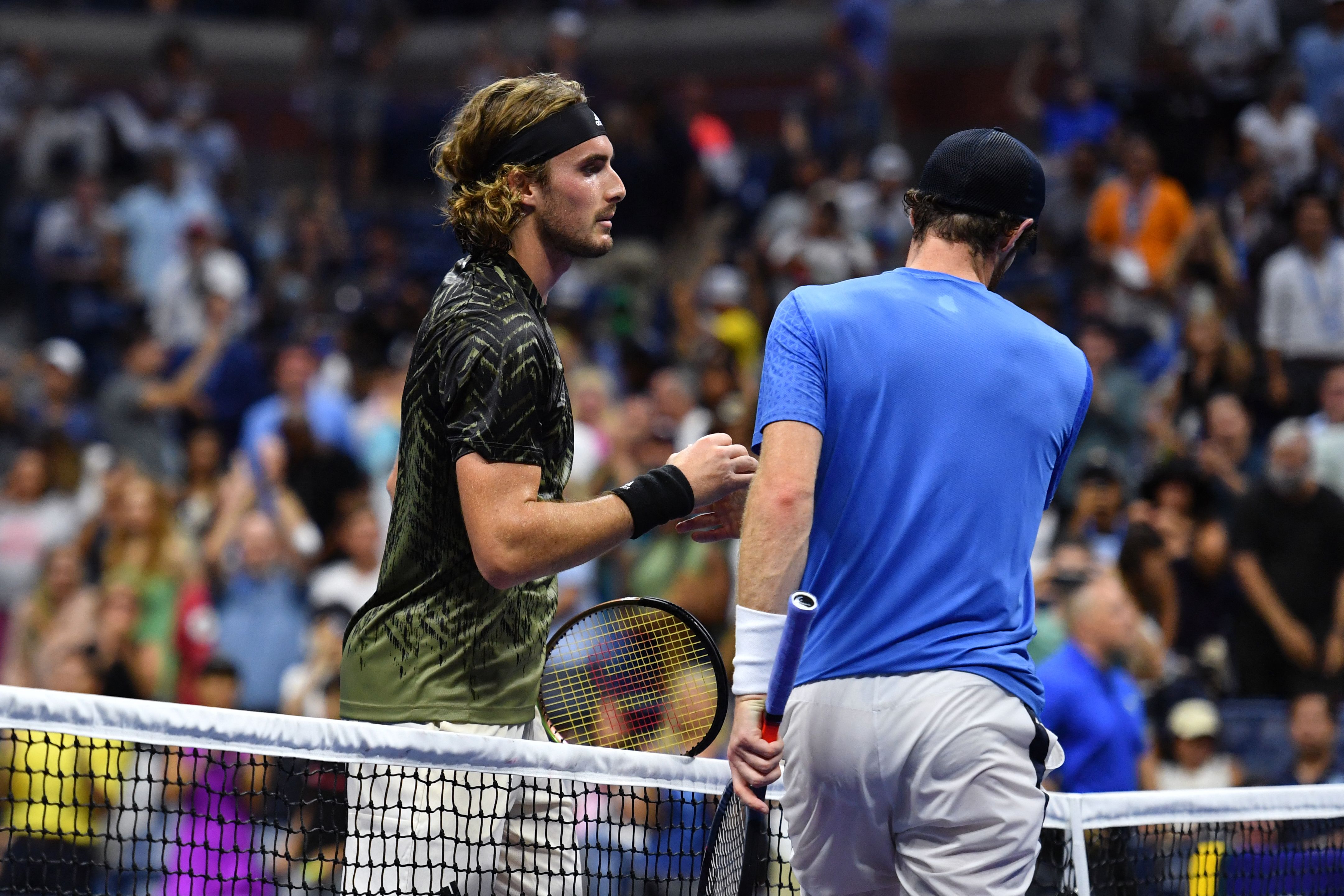 Greece's Stefanos Tsitsipas (L) shakes hands with Britain's Andy Murray after winning their 2021 US Open Tennis tournament men's singles first round match at the USTA Billie Jean King National Tennis Center in New York, on August 30, 2021. (Photo by TIMOTHY A. CLARY / AFP) (Photo by TIMOTHY A. CLARY/AFP via Getty Images)