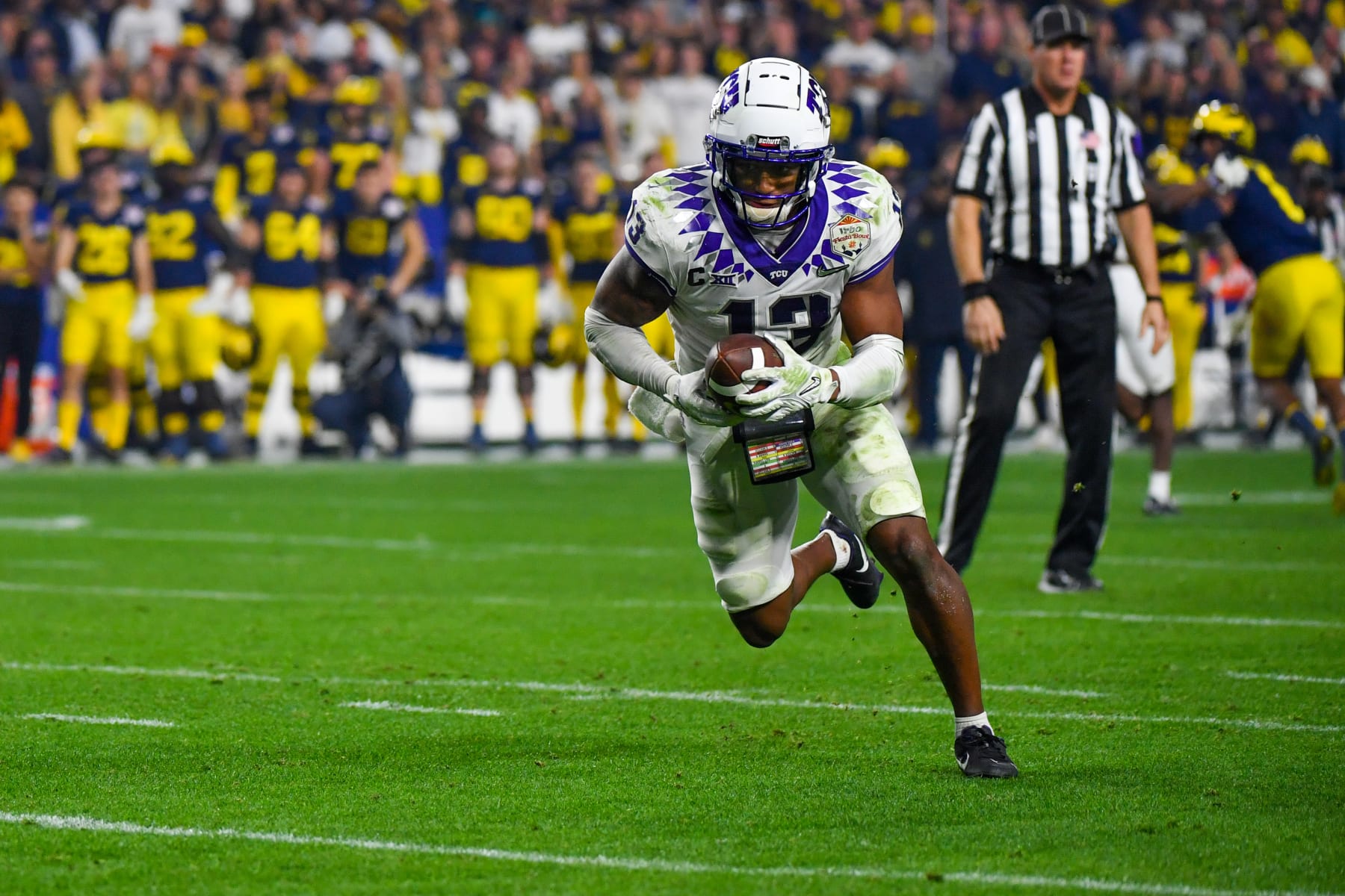 GLENDALE, ARIZONA - DECEMBER 31: Dee Winters #13 of the TCU Horned Frogs intercepts the ball and runs for a touchdown during the second half of the Vrbo Fiesta Bowl college football playoff semifinal game against the Michigan Wolverines at State Farm Stadium on December 31, 2022 in Glendale, Arizona. The TCU Horned Frogs won the game 51-45 over the Michigan Wolverines (Photo by Aaron J. Thornton/Getty Images)
