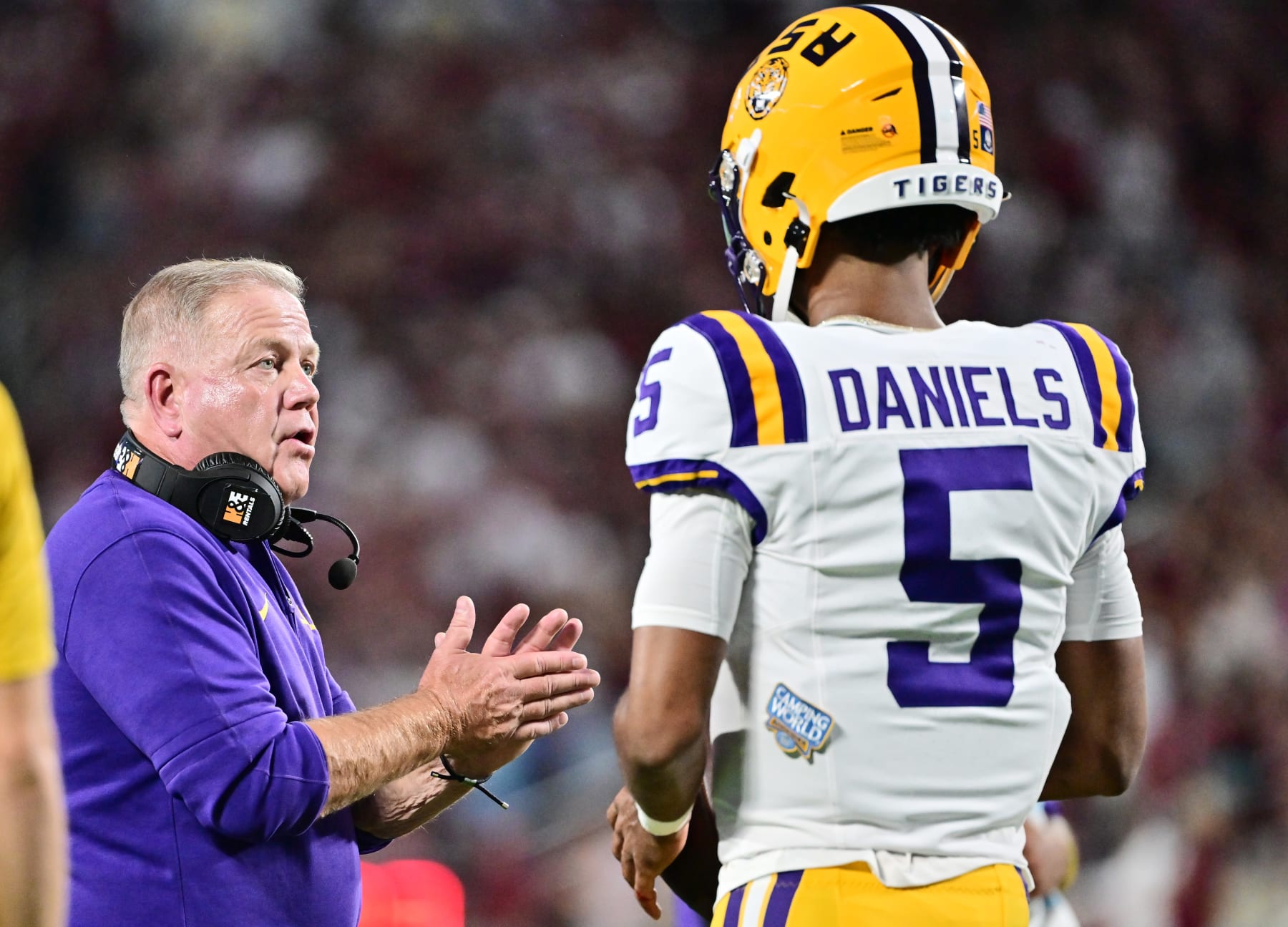ORLANDO, FLORIDA - SEPTEMBER 03: Head coach Brian Kelly of the LSU Tigers talks with Jayden Daniels #5 during a timeout in the first quarter against the Florida State Seminoles at Camping World Stadium on September 03, 2023 in Orlando, Florida. (Photo by Julio Aguilar/Getty Images)