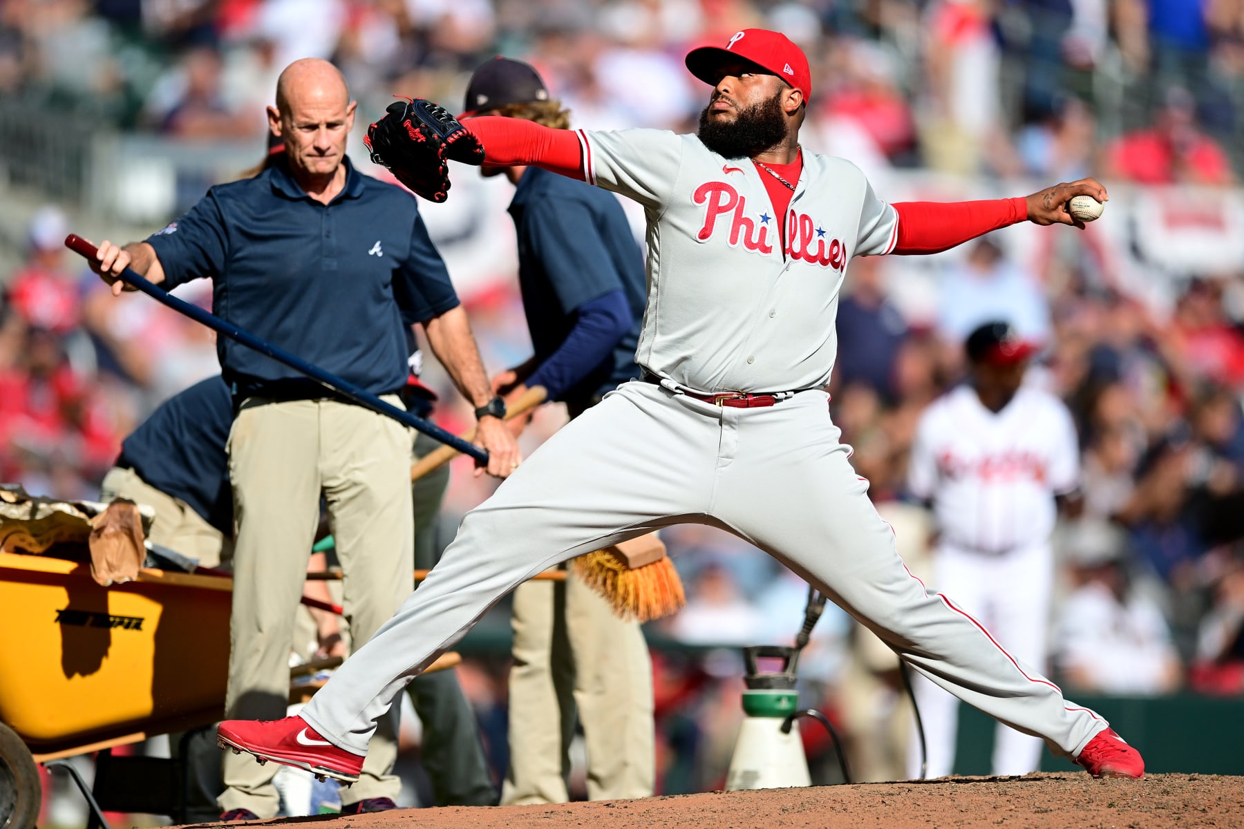 ATLANTA, GEORGIA - OCTOBER 11: Jose Alvarado #46 of the Philadelphia Phillies pitches while the grounds crew fixes the mound during the eighth inning against the Atlanta Braves in game one of the National League Division Series at Truist Park on October 11, 2022 in Atlanta, Georgia. (Photo by Adam Hagy/Getty Images)