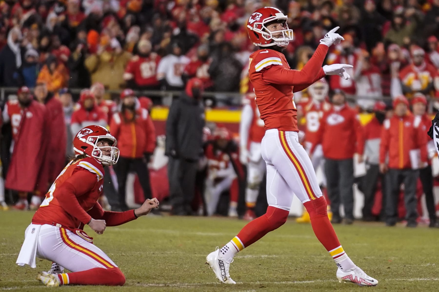 Kansas City Chiefs place kicker Harrison Butker, right, watches his game-winning field goal against the Cincinnati Bengals during the second half of the NFL AFC Championship playoff football game, Sunday, Jan. 29, 2023, in Kansas City, Mo. The Chiefs won 23-20. (AP Photo/Brynn Anderson)