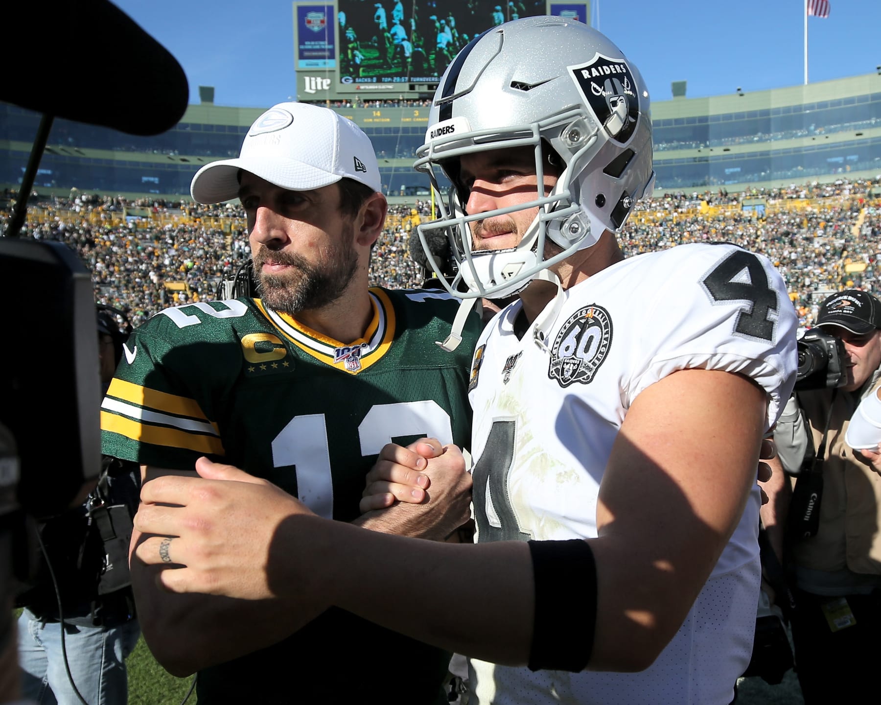 GREEN BAY, WISCONSIN - OCTOBER 20:  Aaron Rodgers #12 of the Green Bay Packers and Derek Carr #4 of the Oakland Raiders meet after the Packers beat the Raiders 42-24 at Lambeau Field on October 20, 2019 in Green Bay, Wisconsin. (Photo by Dylan Buell/Getty Images)