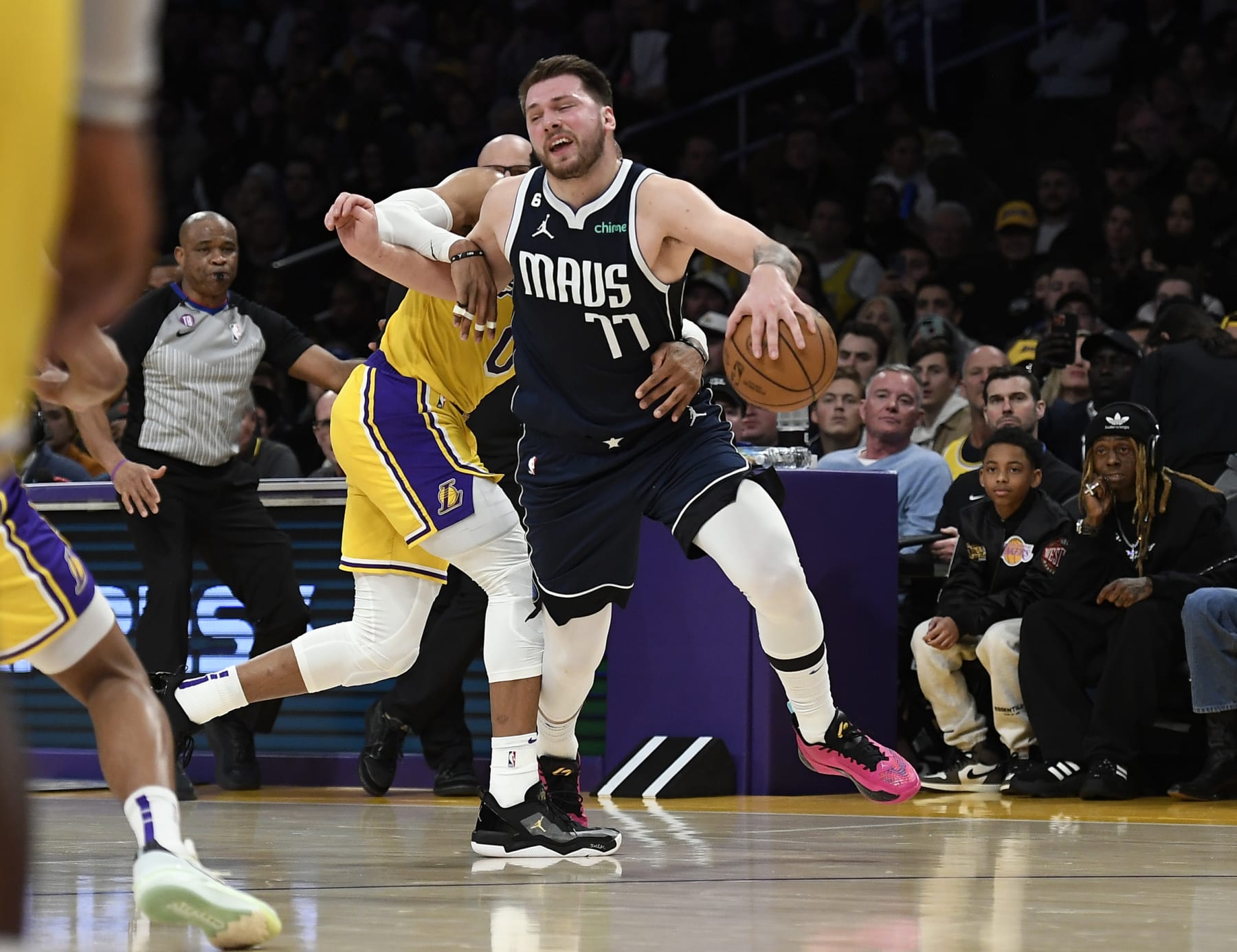 LOS ANGELES, CA - JANUARY 12: Luka Doncic #77 of the Dallas Mavericks is fouled by Russell Westbrook #0 of the Los Angeles Lakers during the first half at Crypto.com Arena on January 12, 2023 in Los Angeles, California. NOTE TO USER: User expressly acknowledges and agrees that, by downloading and or using this photograph, User is consenting to the terms and conditions of the Getty Images License Agreement. (Photo by Kevork Djansezian/Getty Images)