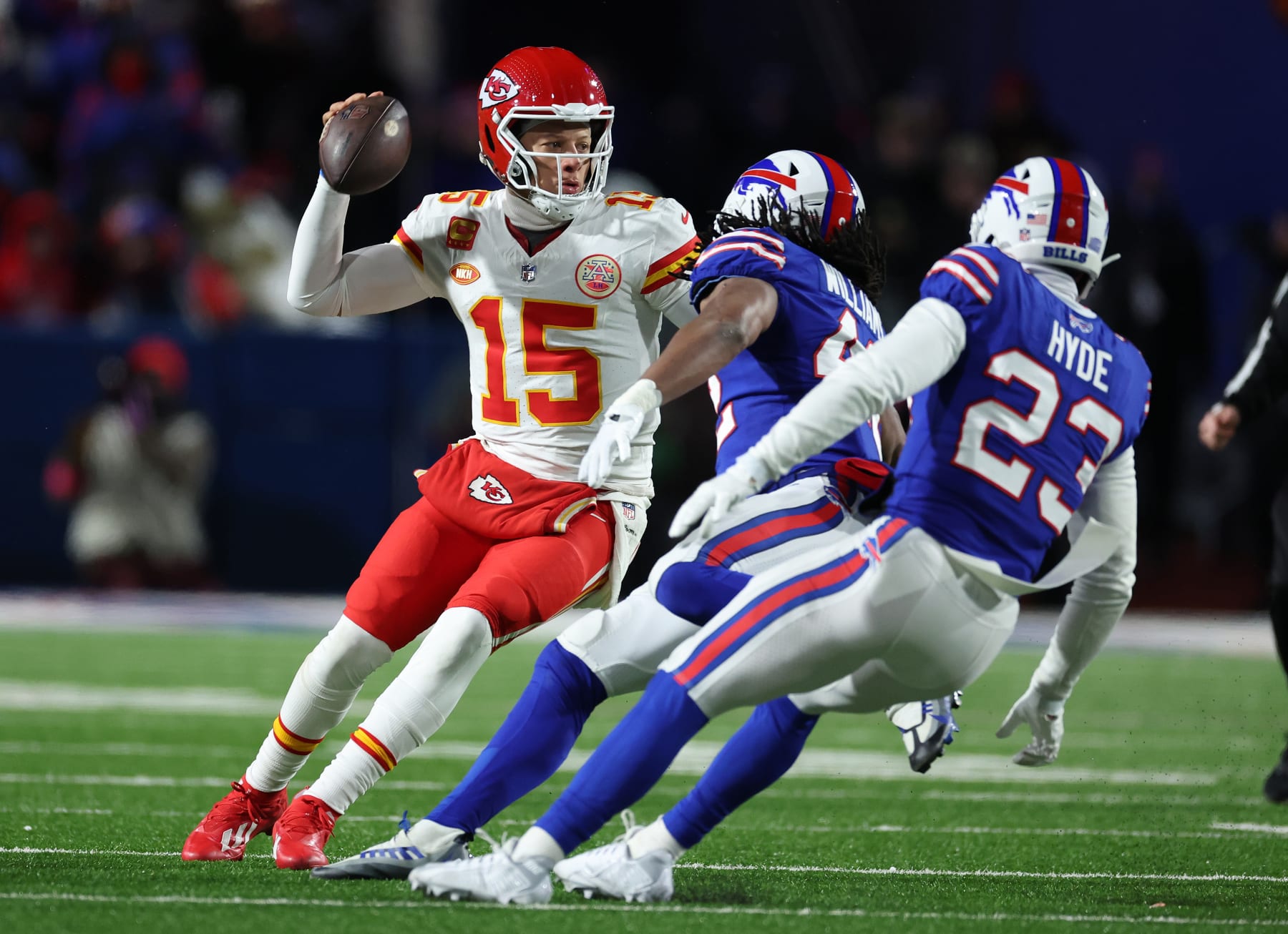 ORCHARD PARK, NEW YORK - JANUARY 21:  Patrick Mahomes #15 of the Kansas City Chiefs dodges Micah Hyde #23 of the Buffalo Bills during their AFC Divisional Playoff game at Highmark Stadium on January 21, 2024 in Orchard Park, New York.  (Photo by Al Bello/Getty Images)