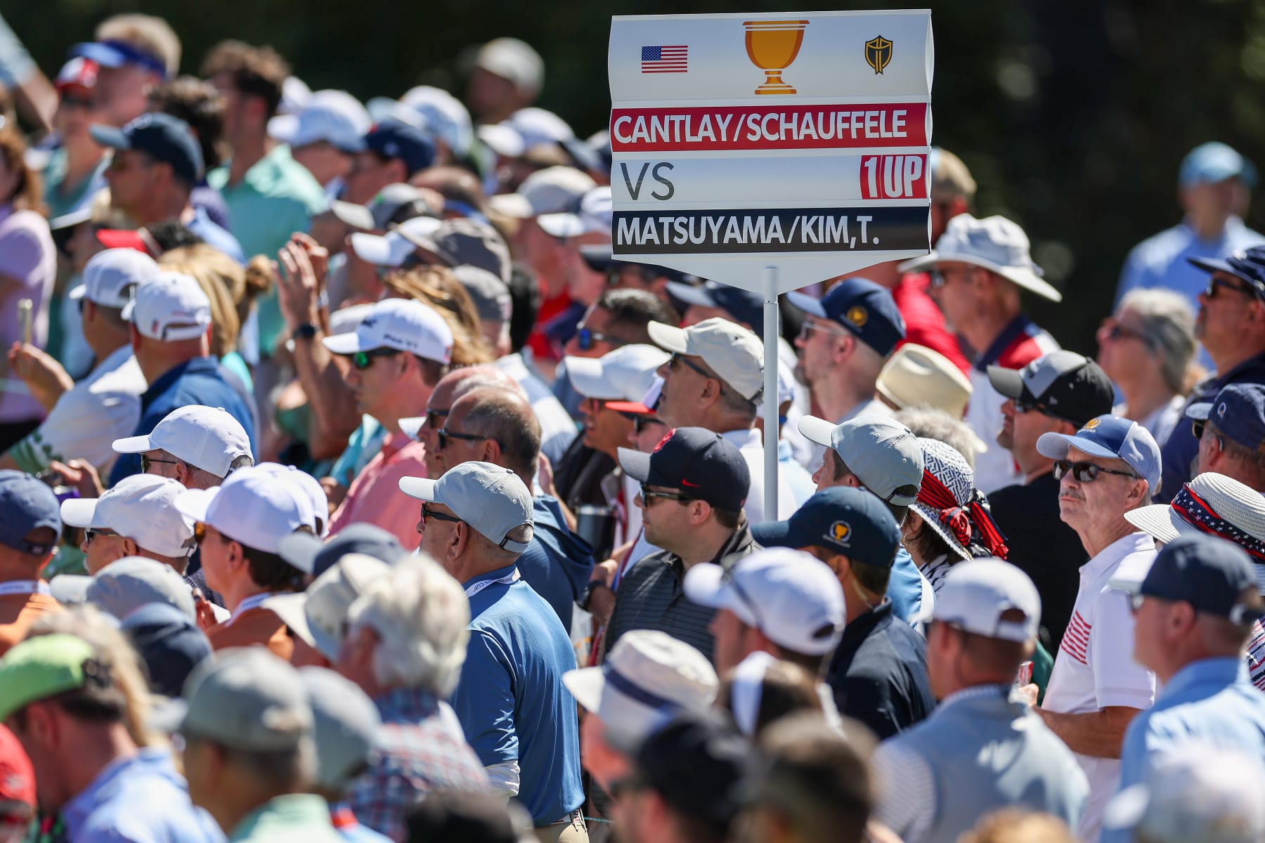 CHARLOTTE, NORTH CAROLINA - SEPTEMBER 23: A standard with the names of Patrick Cantlay and Xander Schauffele of the United States Team along with Hideki Matsuyama of Japan and Tom Kim of South Korea and the International Team is seen among fans during Friday four-ball matches on day two of the 2022 Presidents Cup at Quail Hollow Country Club on September 23, 2022 in Charlotte, North Carolina. (Photo by Rob Carr/Getty Images)