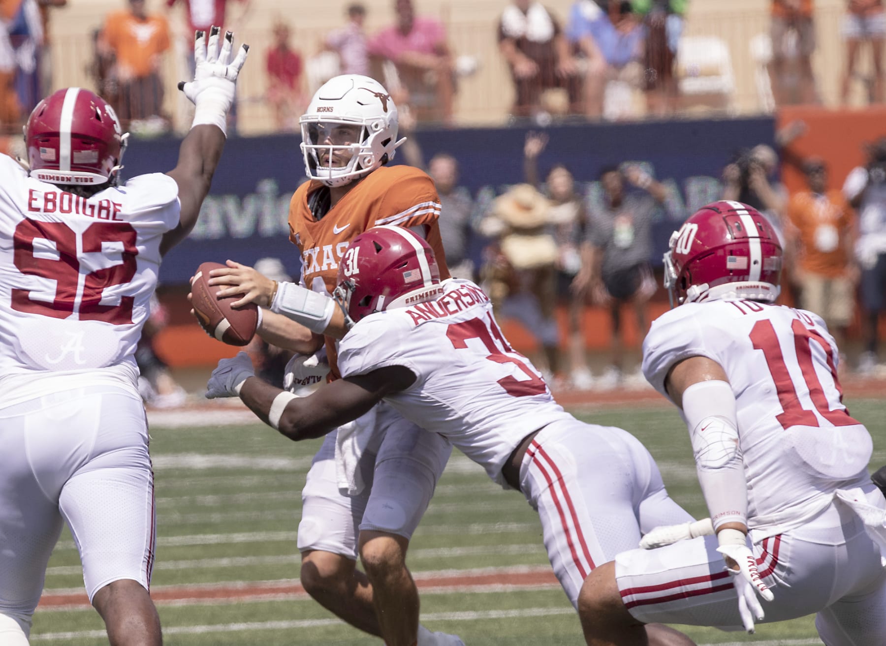 Texas quarterback Hudson Card (1) is sacked by Alabama linebacker Will Anderson Jr. (31) as Justin Eboigbe (92) and linebacker Henry To'oTo'o (10) help defend during the second half of an NCAA college football game, Saturday, Sept. 10, 2022, in Austin, Texas. Alabama defeated Texas 20-19. (AP Photo/Rodolfo Gonzalez)