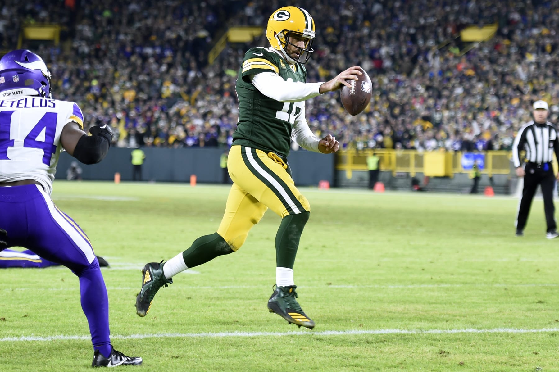 GREEN BAY, WISCONSIN - JANUARY 01: Aaron Rodgers #12 of the Green Bay Packers runs for a two yard touchdown during the fourth quarter Minnesota Vikings at Lambeau Field on January 01, 2023 in Green Bay, Wisconsin. (Photo by Kayla Wolf/Getty Images)