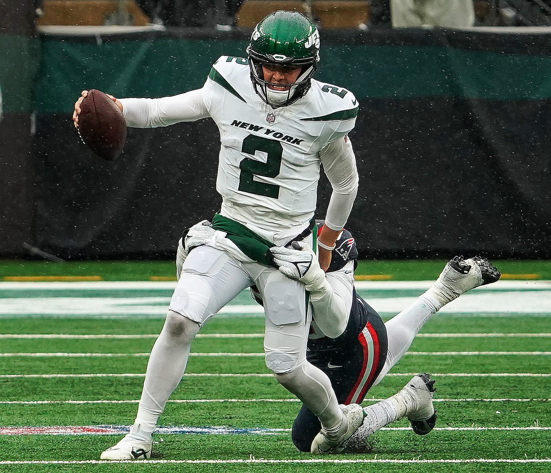 East Rutherford, NJ - September 24: New York Jets QB Zach Wilson attempts to escape the pocket. The Jets lost to the New England Patriots, 15-10. (Photo by Barry Chin/The Boston Globe via Getty Images)