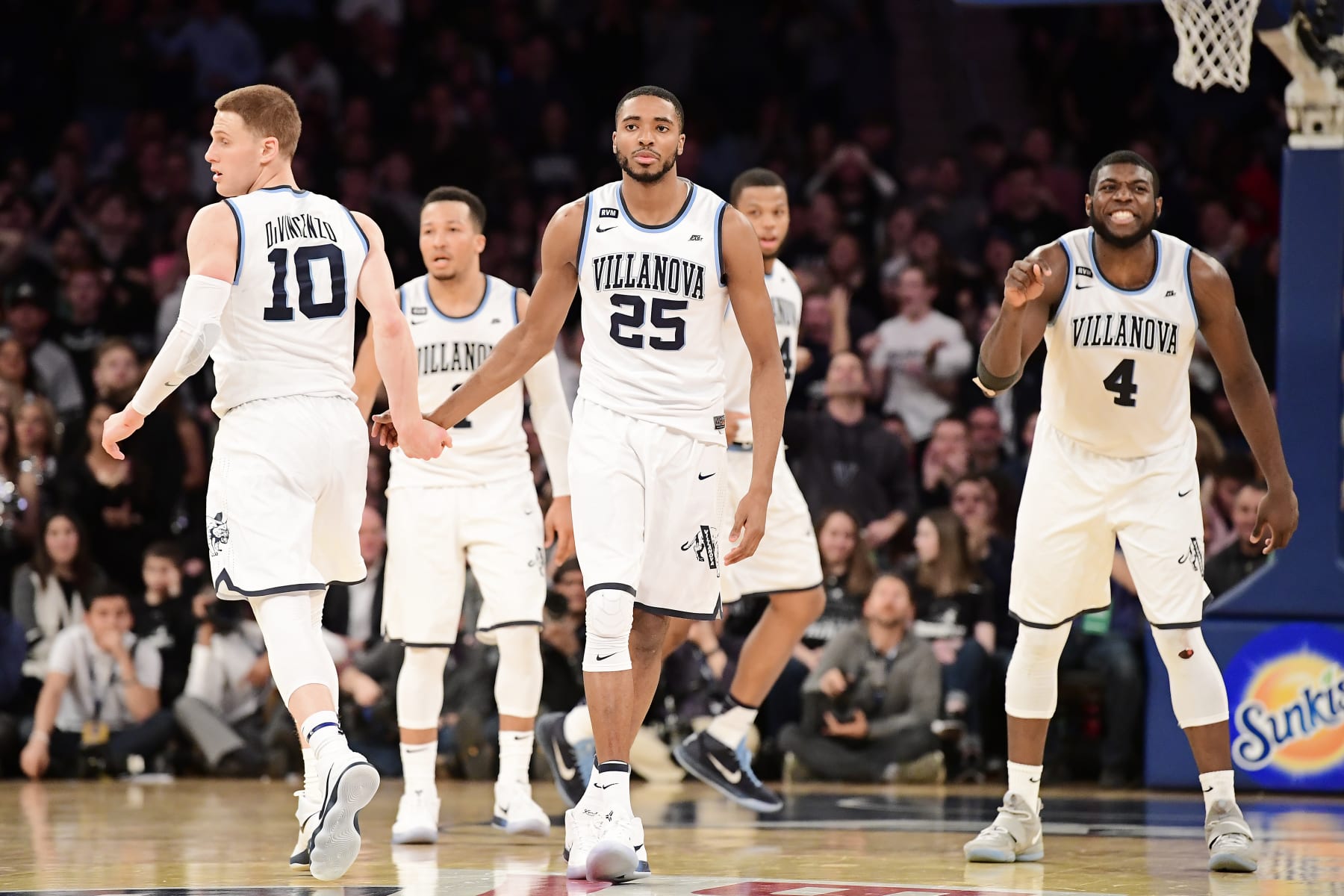 NEW YORK, NY - MARCH 10: Donte DiVincenzo #10, Mikal Bridges #25 and Eric Paschall #4 of the Villanova Wildcats celebrate their lead against the Providence Friars during the championship game of the Big East Basketball Tournament at Madison Square Garden on March 10, 2018 in New York City.  (Photo by Steven Ryan/Getty Images)
