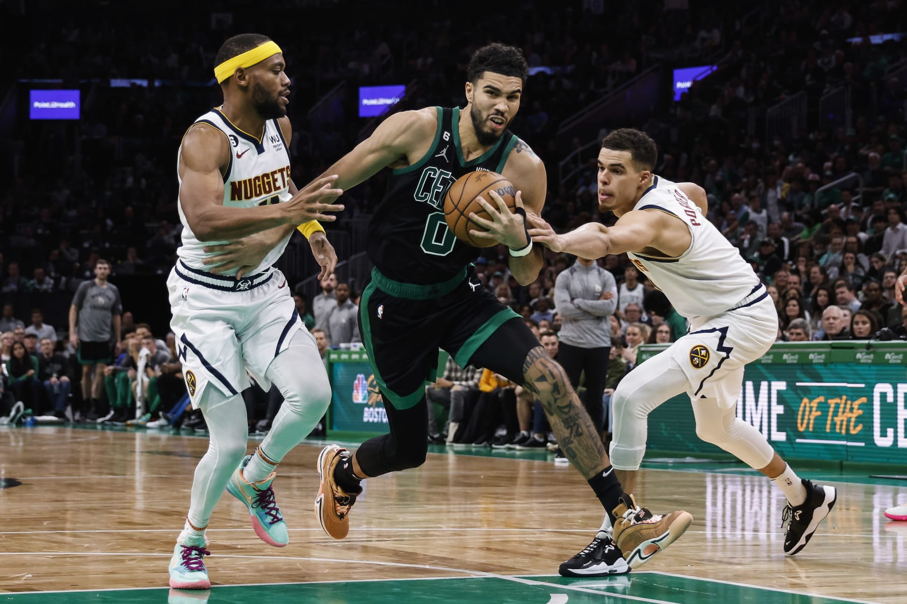 BOSTON, MA - NOVEMBER 11: Jayson Tatum #0 of the Boston Celtics goes between Bruce Brown #11 of the Denver Nuggets, left, and Michael Porter Jr. during the second half at TD Garden on November 11, 2022 in Boston, Massachusetts. NOTE TO USER: User expressly acknowledges and agrees that, by downloading and/or using this Photograph, user is consenting to the terms and conditions of the Getty Images License Agreement. (Photo By Winslow Townson/Getty Images)