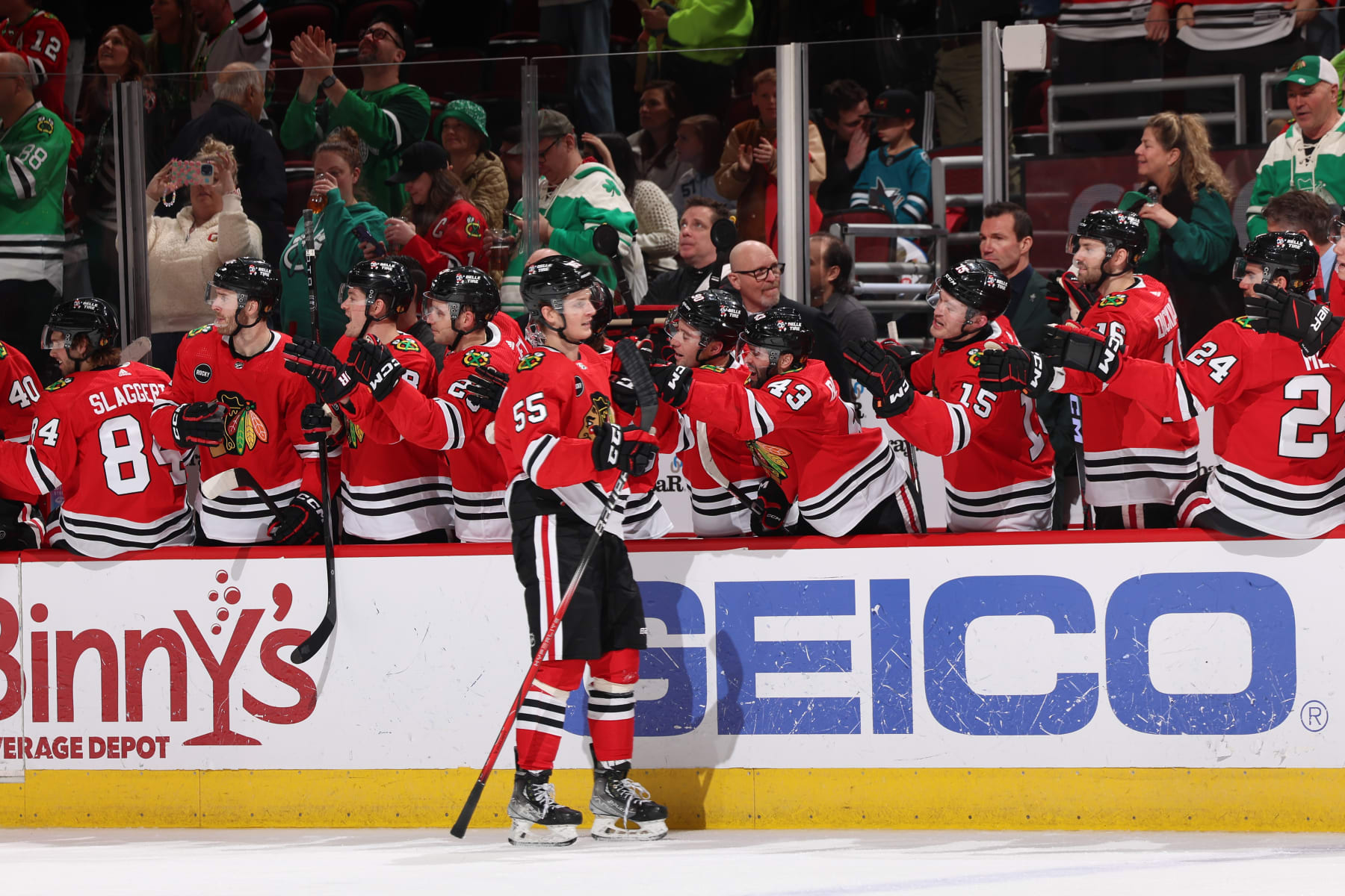 CHICAGO, ILLINOIS - MARCH 17: Kevin Korchinski #55 of the Chicago Blackhawks reacts at the bench after scoring against the San Jose Sharks in the third period at the United Center on March 17, 2024 in Chicago, Illinois. (Photo by Chase Agnello-Dean/NHLI via Getty Images)