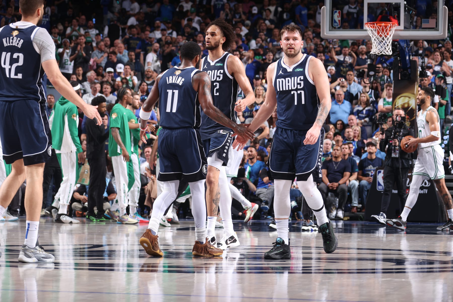 DALLAS, TX - JUNE 12: Kyrie Irving #11 high fives Luka Doncic #77 and Dereck Lively II #2 of the Dallas Mavericks during the game against the Boston Celtics during Game 3 of the 2024 NBA Finals on June 12, 2024 at the American Airlines Center in Dallas, Texas. NOTE TO USER: User expressly acknowledges and agrees that, by downloading and or using this photograph, User is consenting to the terms and conditions of the Getty Images License Agreement. Mandatory Copyright Notice: Copyright 2024 NBAE (Photo by Nathaniel S. Butler/NBAE via Getty Images)