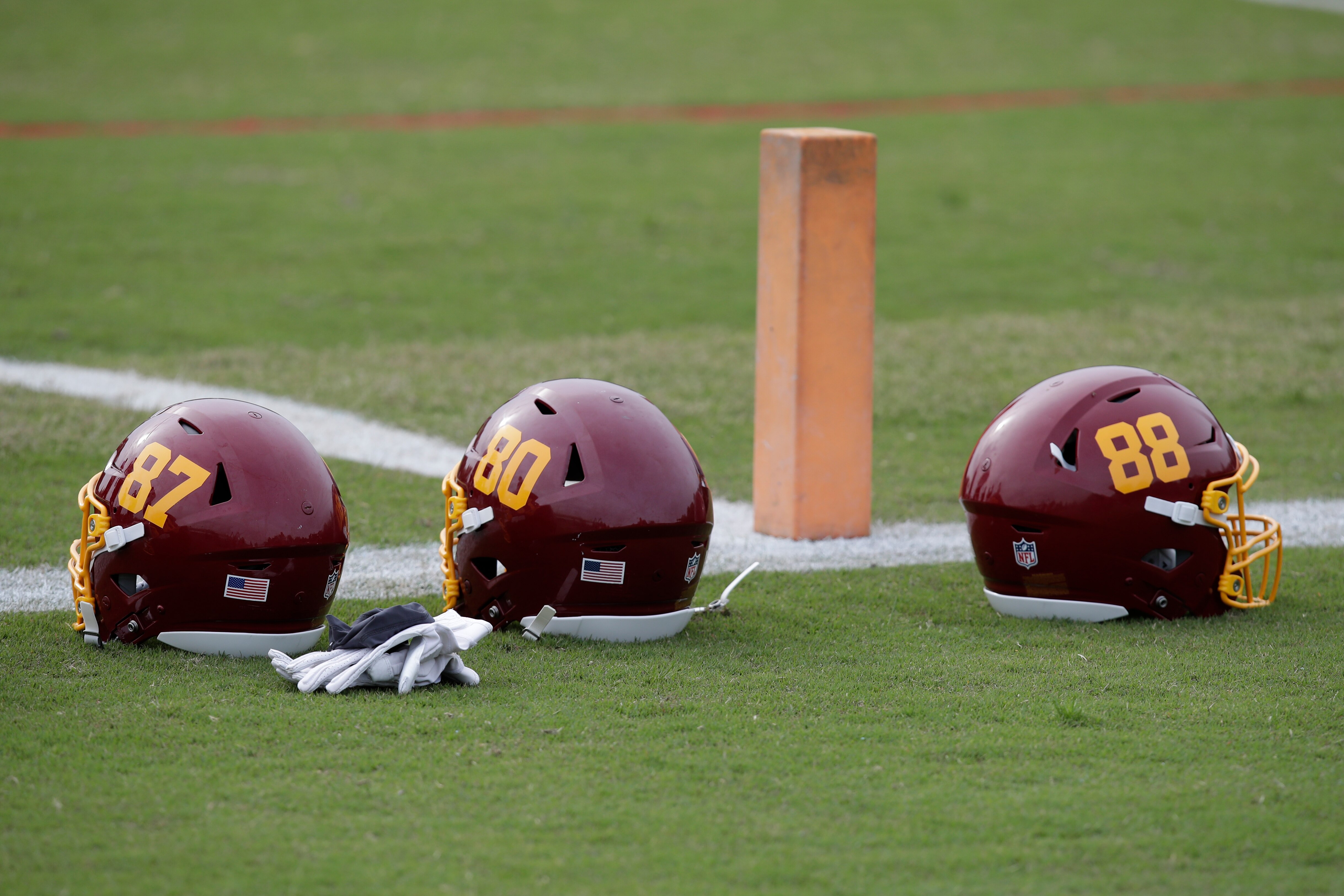 Washington Football Team helmets are seen on the field during an NFL football OTA at Inova Sports Performance Center in Ashburn, Va., Wednesday, June 2, 2021. (AP Photo/Luis M. Alvarez)