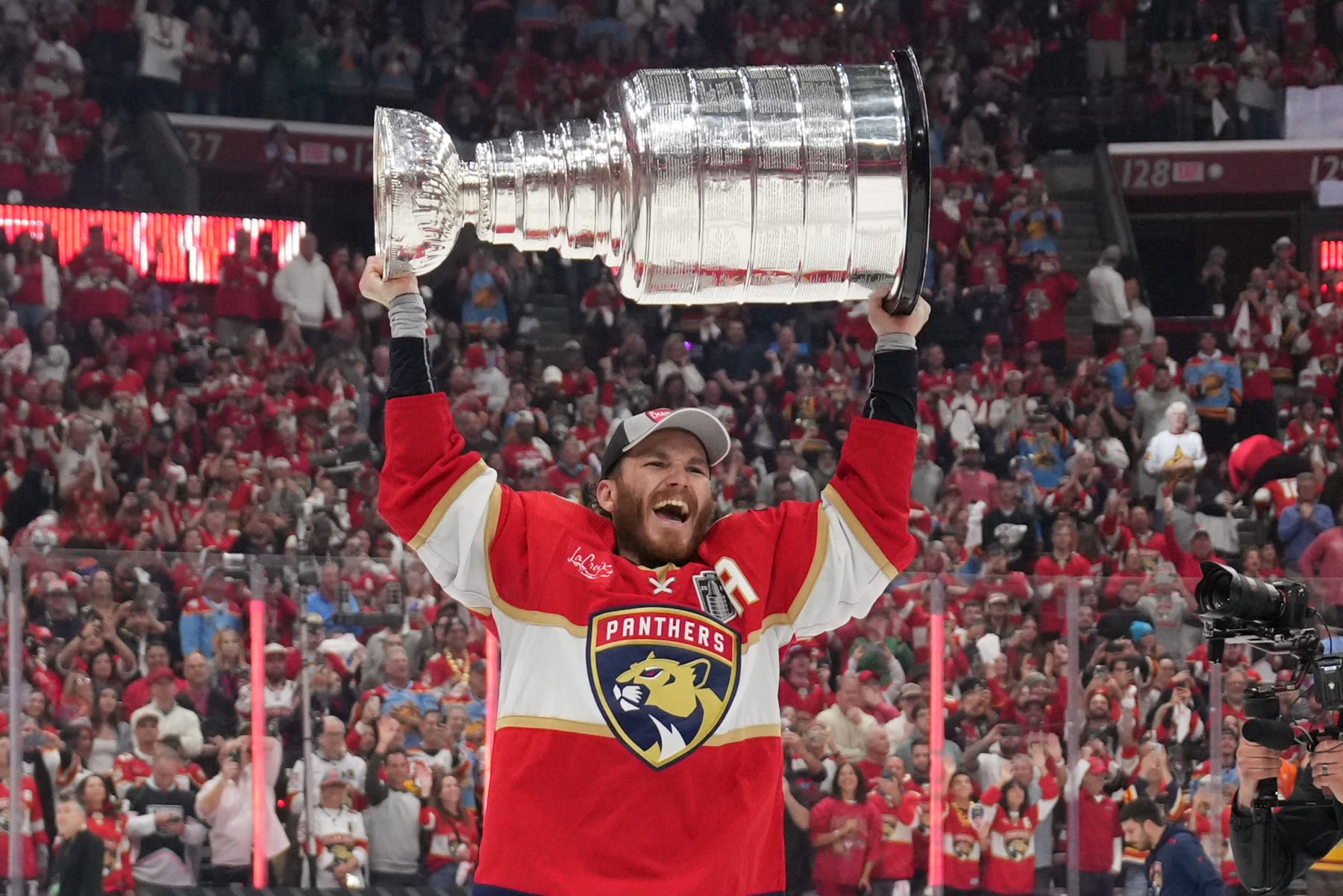 SUNRISE, FL - JUNE 24: Florida Panthers left wing Matthew Tkachuk (19) celebrates with the cup following game seven of the Stanley Cup Finals between the Edmonton Oilers and the Florida Panthers on Monday, June 24, 2024  at Amerant Bank Arena in Sunrise, Fla. (Photo by Peter Joneleit/Icon Sportswire via Getty Images)